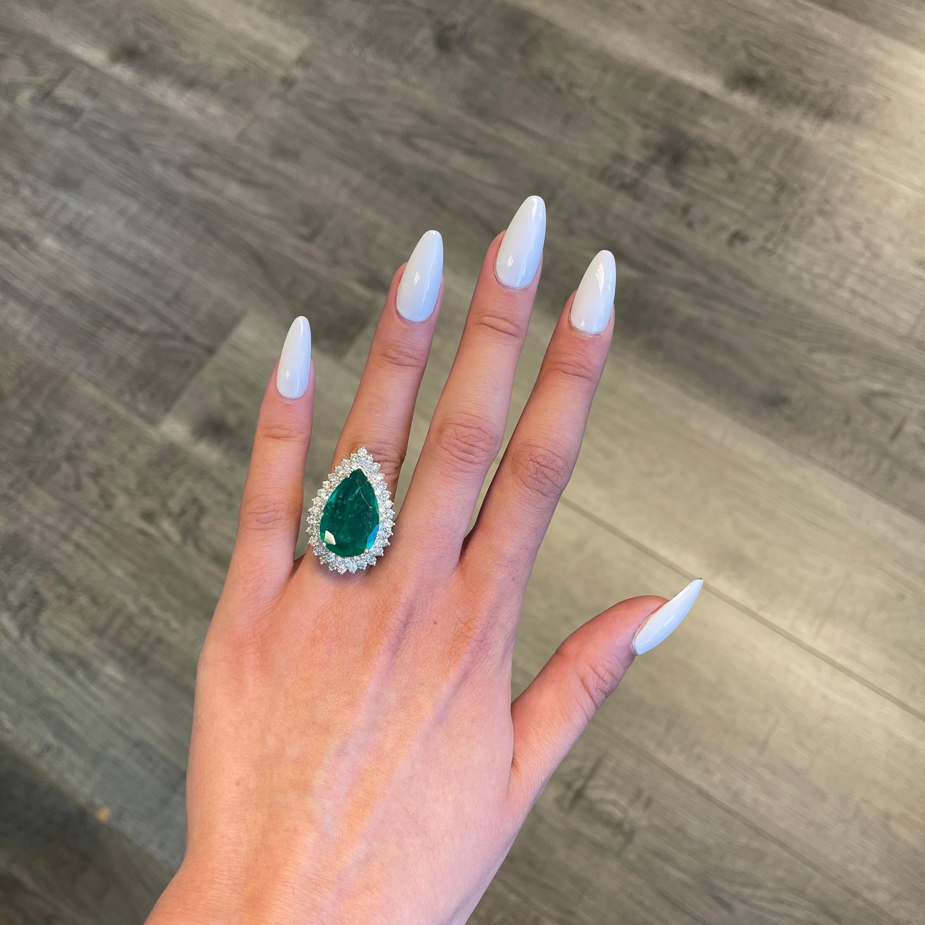Lovely emerald with diamond double halo ring.
8.11 carat pear emerald apx F2 complimented with 59 round brilliant diamonds, 2.21ct. Approximately I/J color and SI clarity. 10.32ct total gemstone weight, in 18k white gold. 
Accommodated with an up to