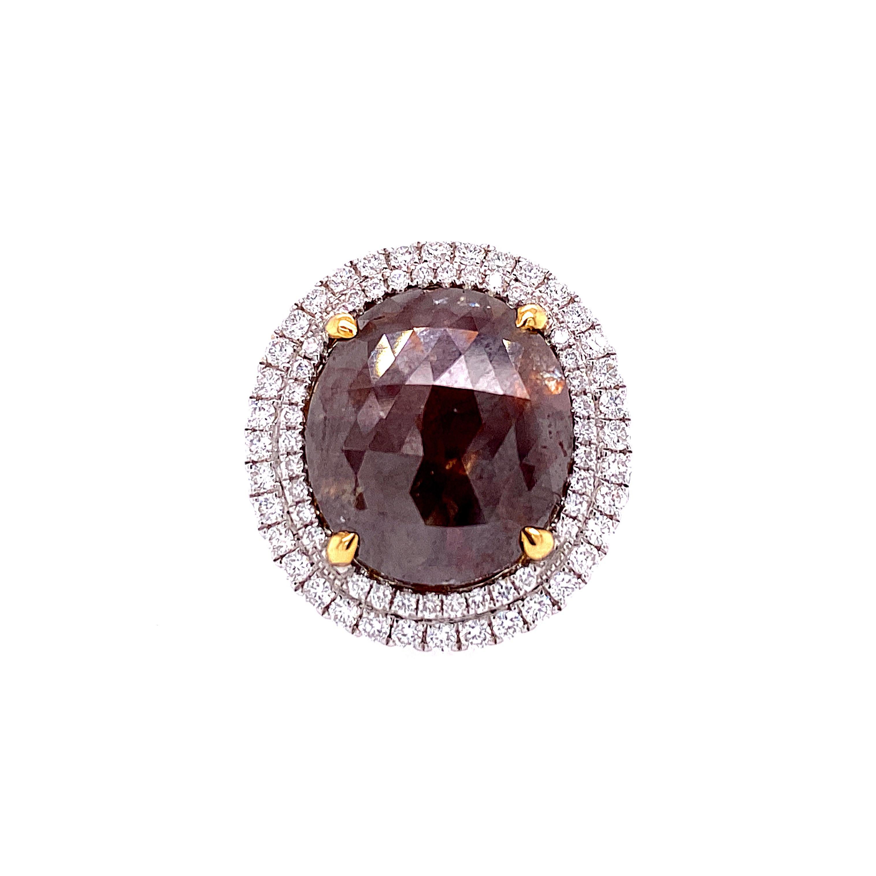 This stunning Cocktail Ring features a beautiful 8.11 Carat Rose Cut Round Brown Diamond, with a Double Diamond Halo. The Brown Diamond sits on a Triple Diamond Shank. This ring is set in 18K White Gold, with 18K Yellow Gold prongs on the center