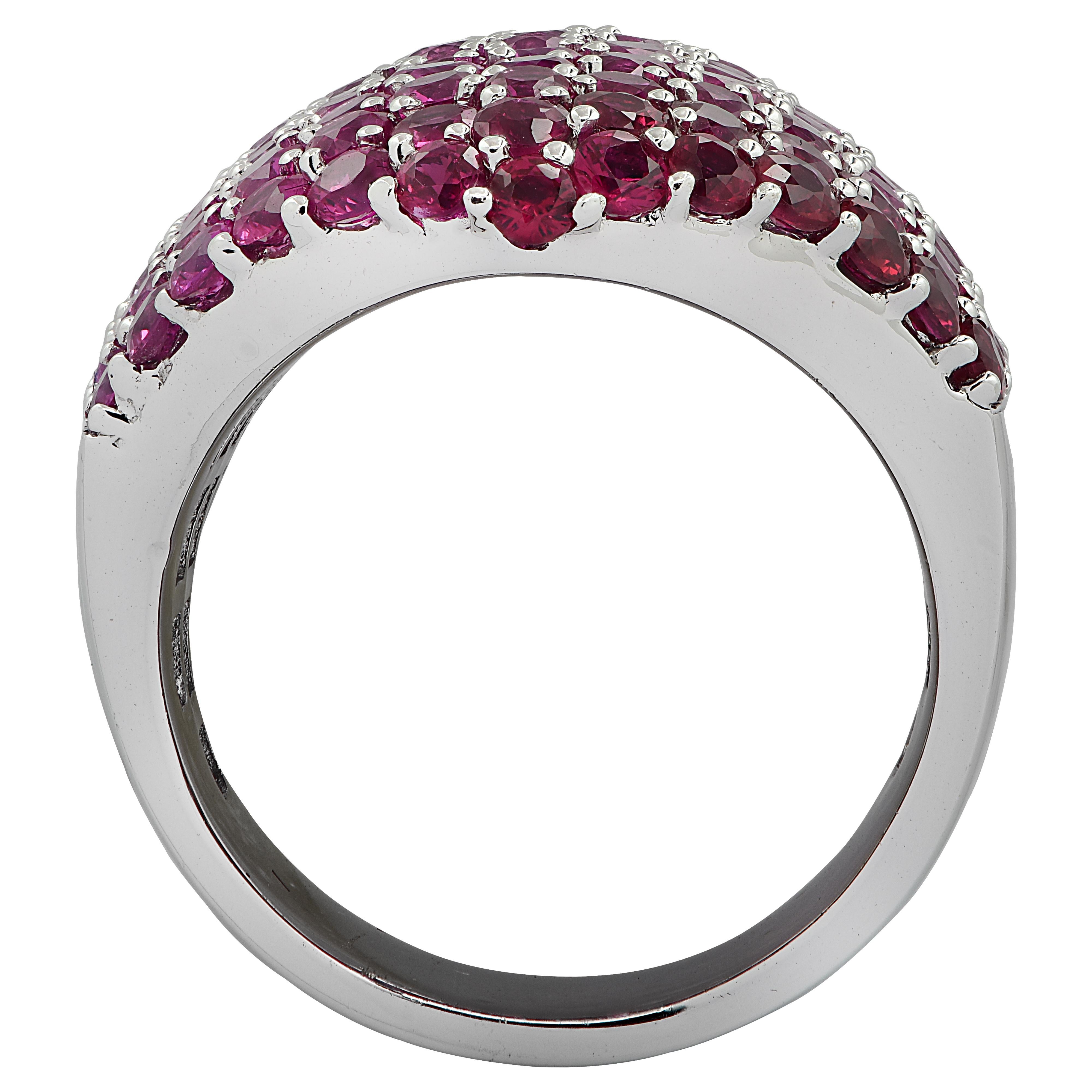 Striking cocktail ring finely crafted in 18 karat white gold, featuring round pink sapphires weighing approximately 6.52 carats total, and round rubies weighing approximately 1.6 carats total, saturating in color from very light pink to deep red.