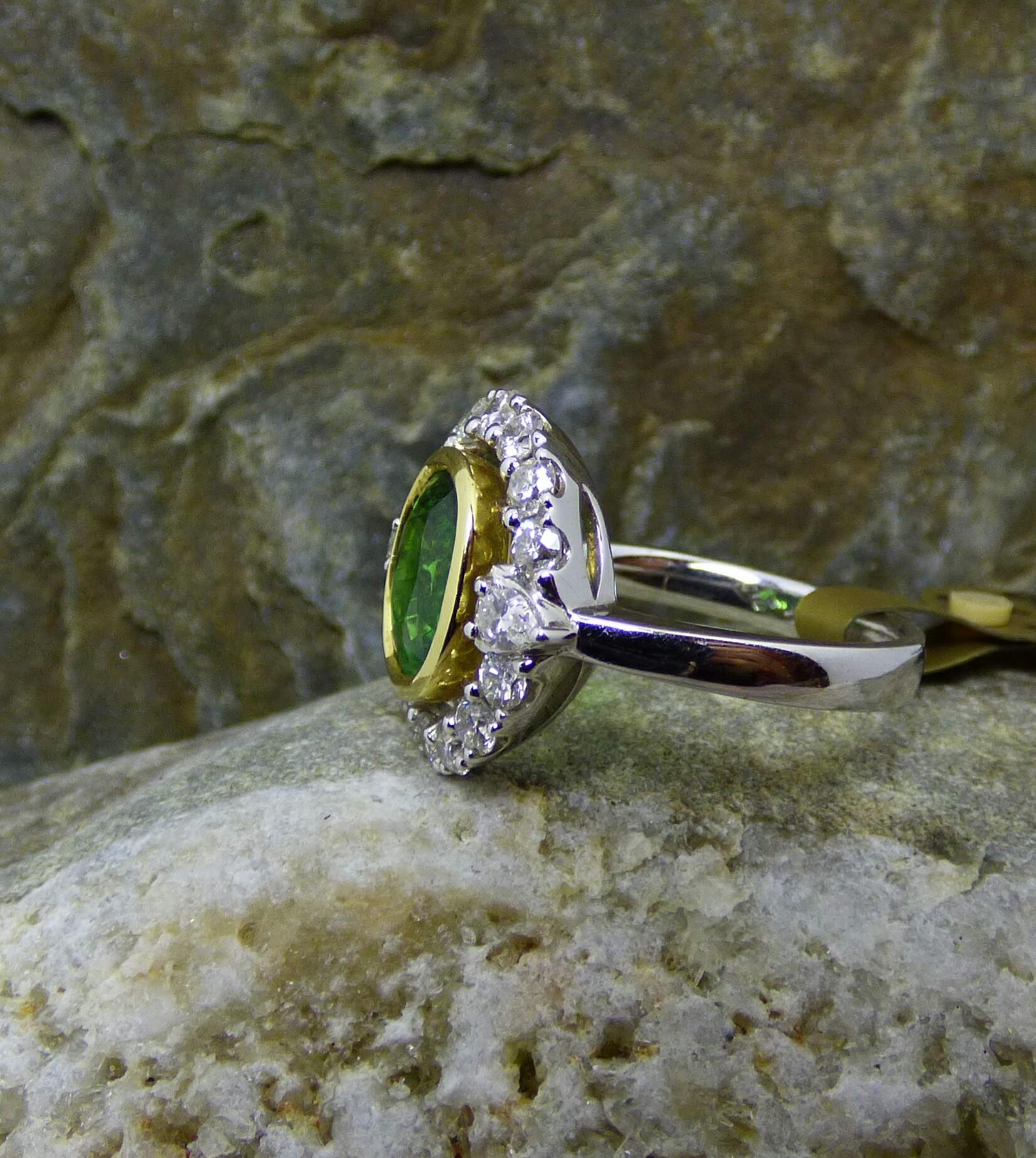Contemporary 8.12ct Oval Tsavorite Garnet and Diamond Cluster Ring in 18K Gold For Sale