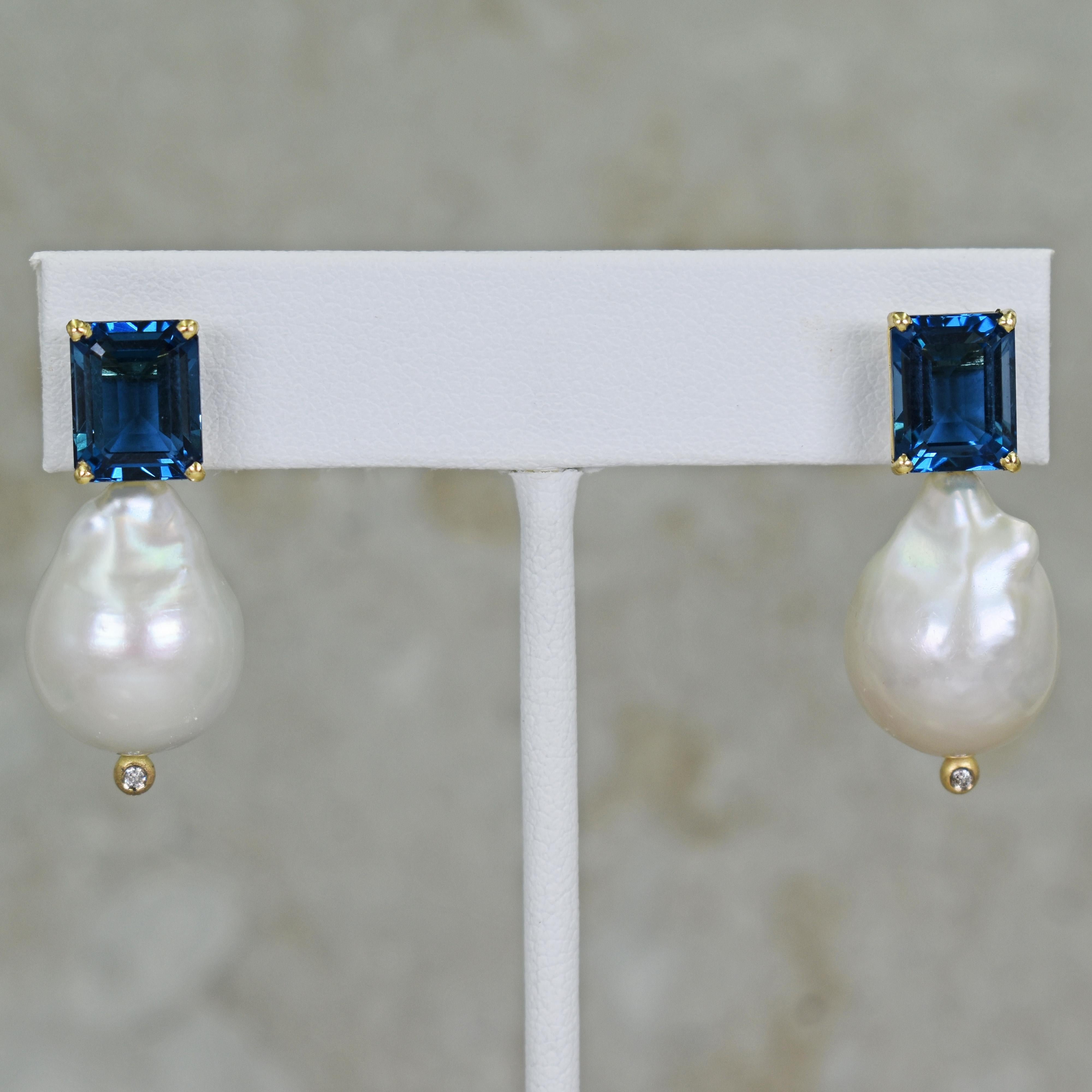 Gorgeous and unique 14k yellow gold stud earrings featuring two emerald-cut London Blue Topaz gemstones, totaling 8.16 carats, Freshwater Baroque Pearls and accent white Diamonds. Stud earrings are 1.32 inches or 33 mm in length. These artisan drop