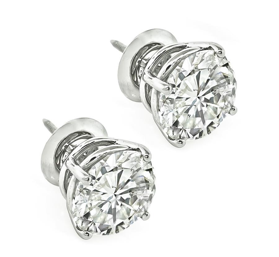 This is a stunning pair of diamond 14k white gold stud earrings. The earrings are set with sparkling round cut diamonds that weigh approximately 4.09ct and 4.07ct. The color of the diamonds is G-H with I1 clarity. The total weight of the diamonds is