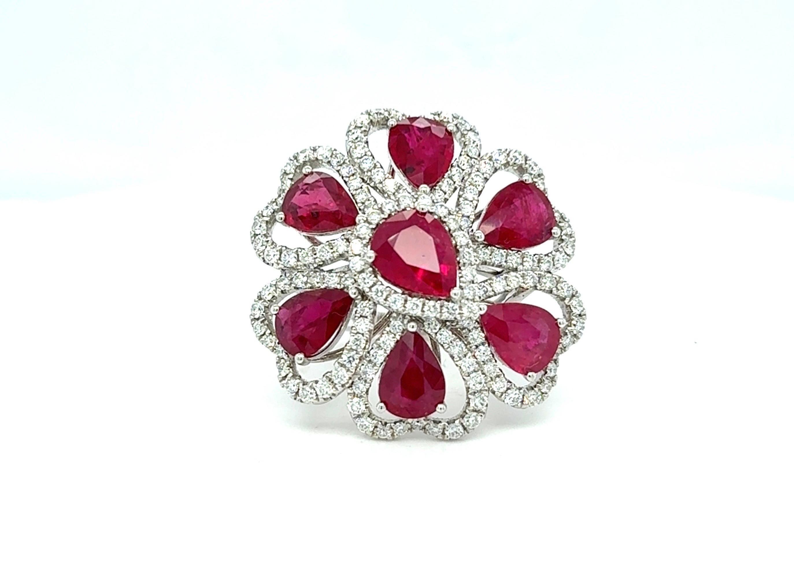 Ein bezaubernder Ring mit Blumenmotiv besteht aus 8,17 Karat Rubinen im Birnenschliff, die jeweils von einem funkelnden Diamantenhalo umgeben sind. Dieses Meisterwerk aus 14 Karat Weißgold ist mit insgesamt 1,56 Karat weißen Brillanten besetzt und