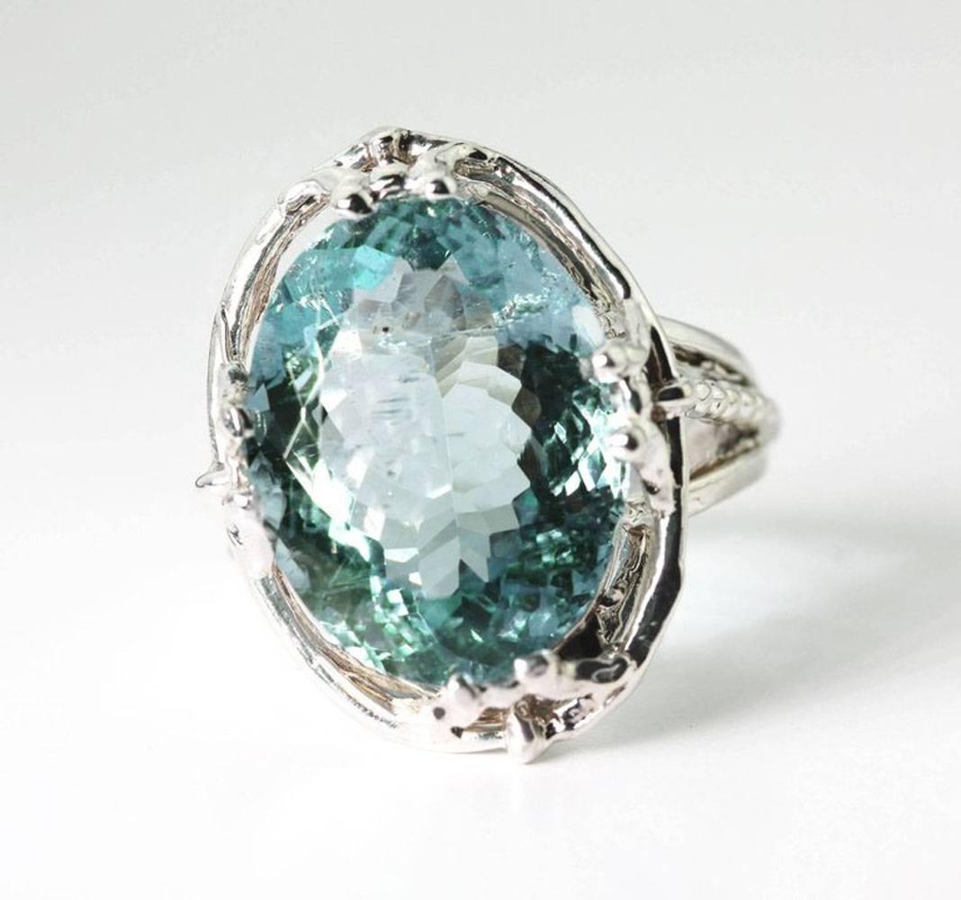 Bright sparkling natural oval 8.18 carat Brazilian Aquamarine (15. 8 mm x 11.4 mm) is set in a sterling silver ring size 4.5 sizable. The natural inclusions in the gem make it glitter more and it loves to go to dinner and parties.  