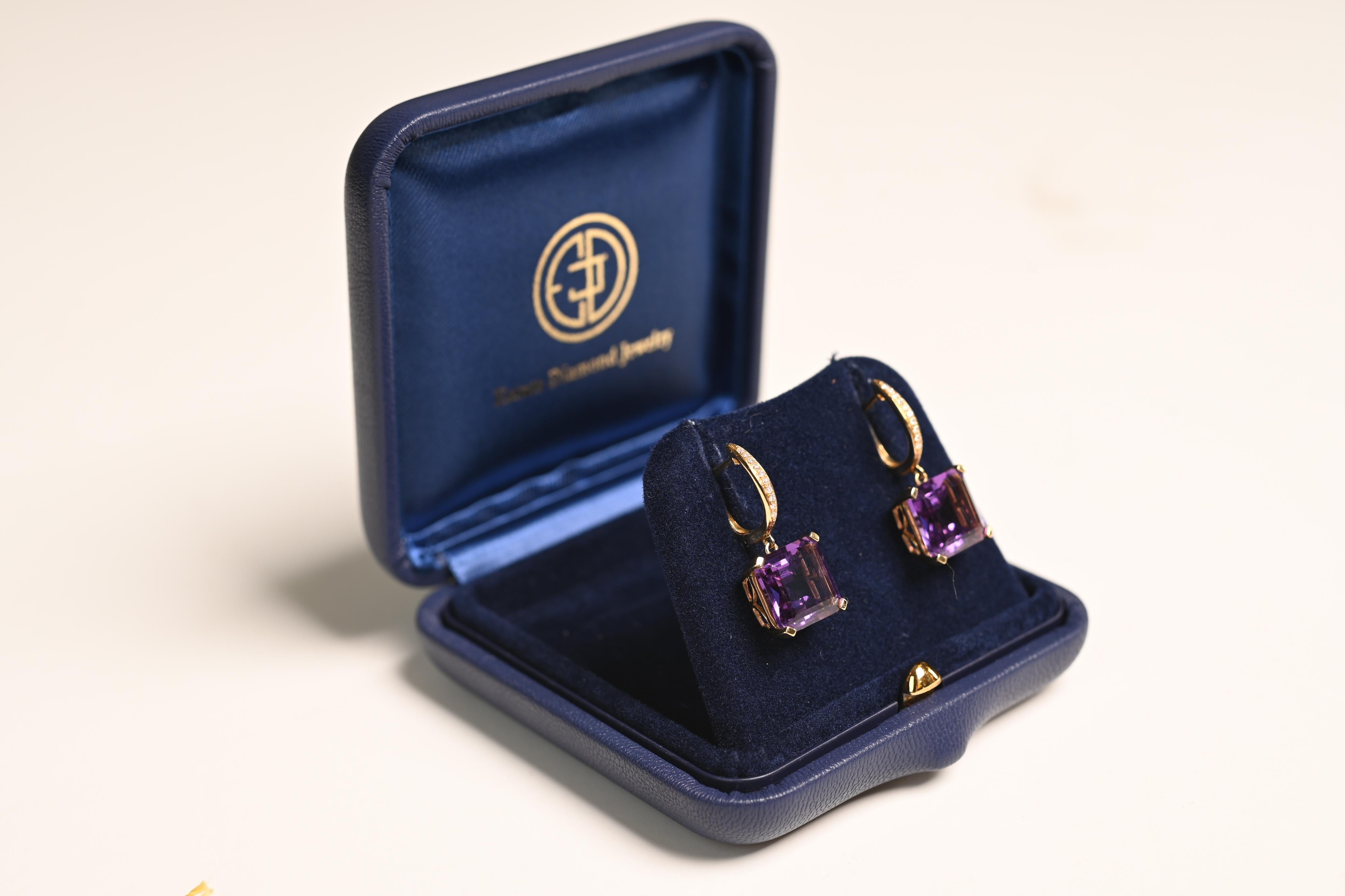 These stunning gemstone earrings showcase exquisite emerald-cut amethysts with a total combined weight of approx 8.10-carats. The amethysts are elegantly set in 18k yellow gold baskets, offering a refined and timeless look. The design is further
