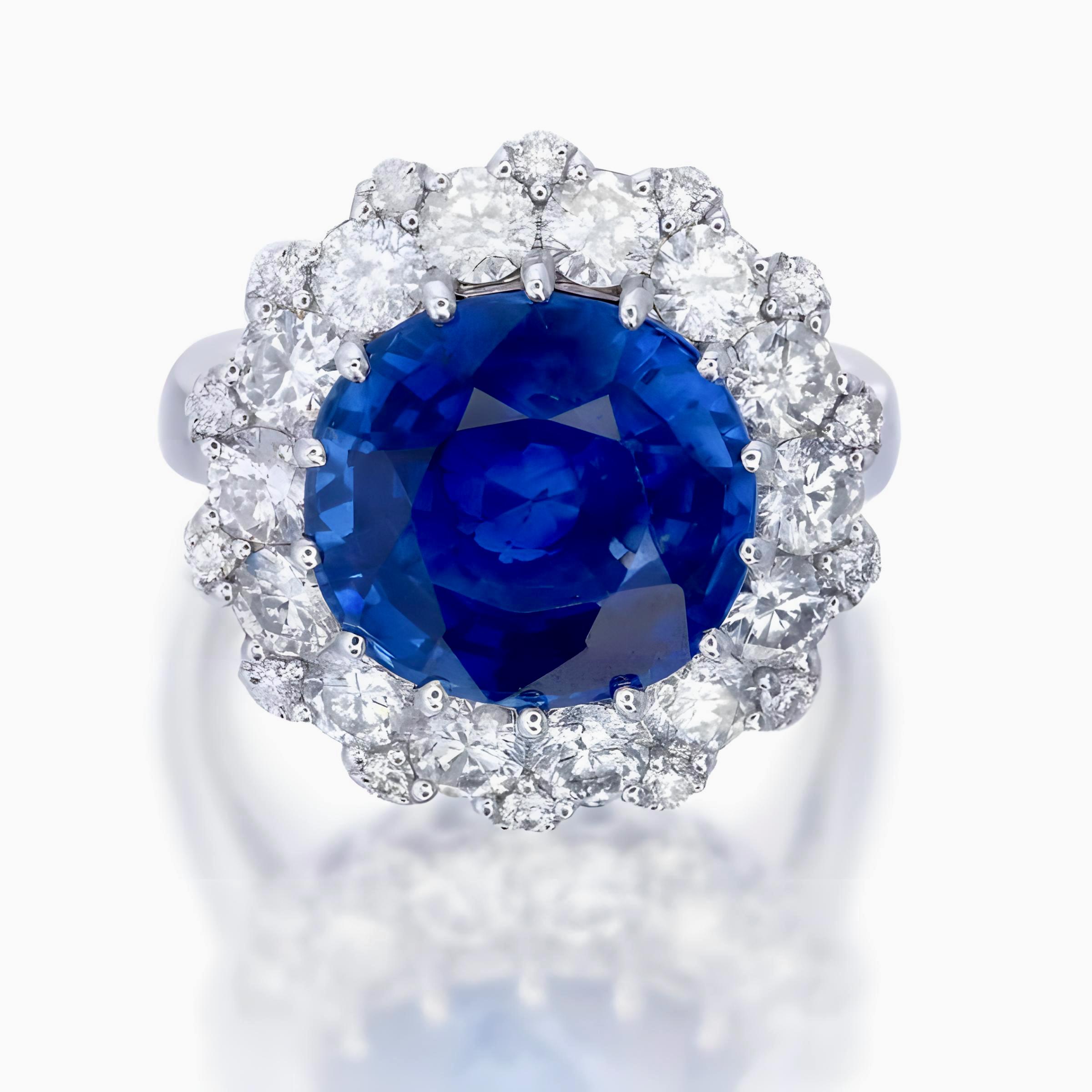 This ring showcases an impressive 8.18-carat heated blue sapphire from Sri Lanka (certificate number GIA2508092435), surrounded by 2.02 carats of round brilliant cut diamonds that highlight its vivid blue color. 

Set in 18-karat white gold, it has