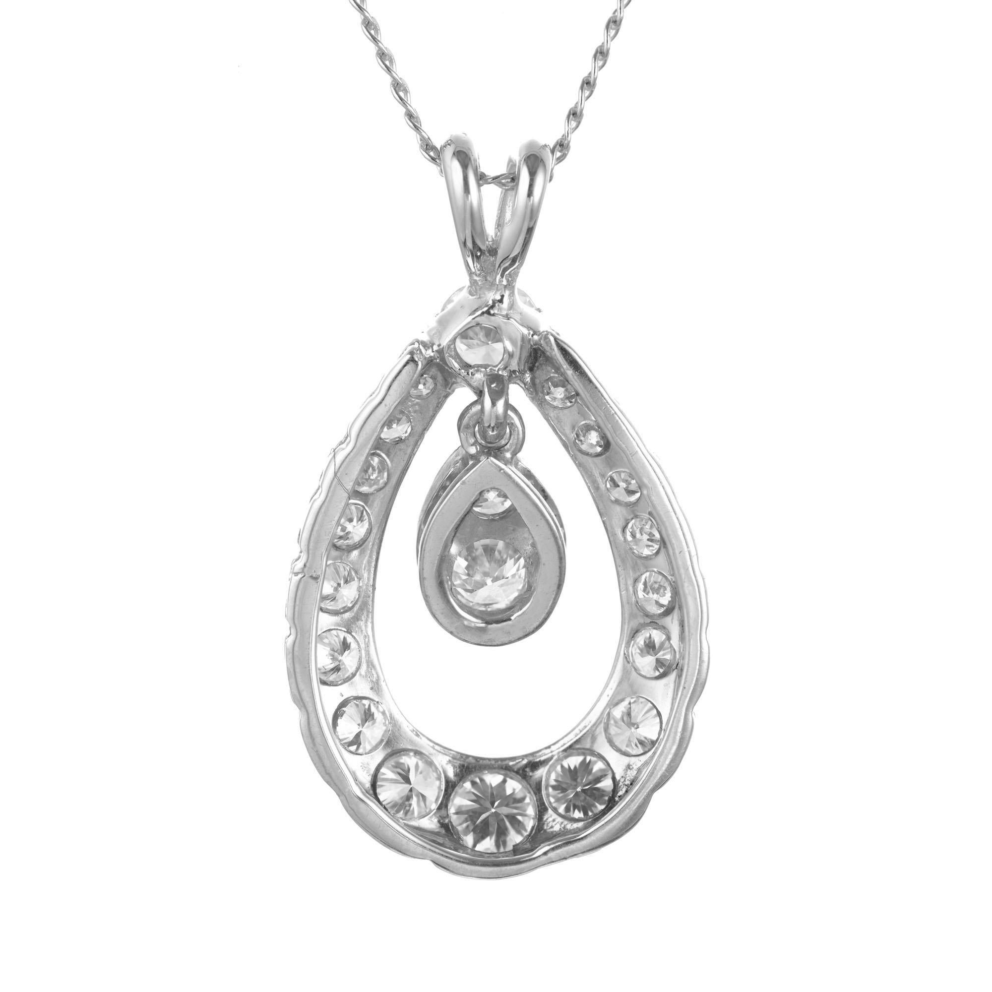 Custom made 1950’s open tear drop shape pendant set with 20 round brilliant cut diamonds in a halo. 14k white gold. Original 16 Inch chain.

20 round brilliant cut diamonds, H-I SI approx. .82cts
14k white gold 
Stamped: 14k
3.2 grams
Top to bottom: