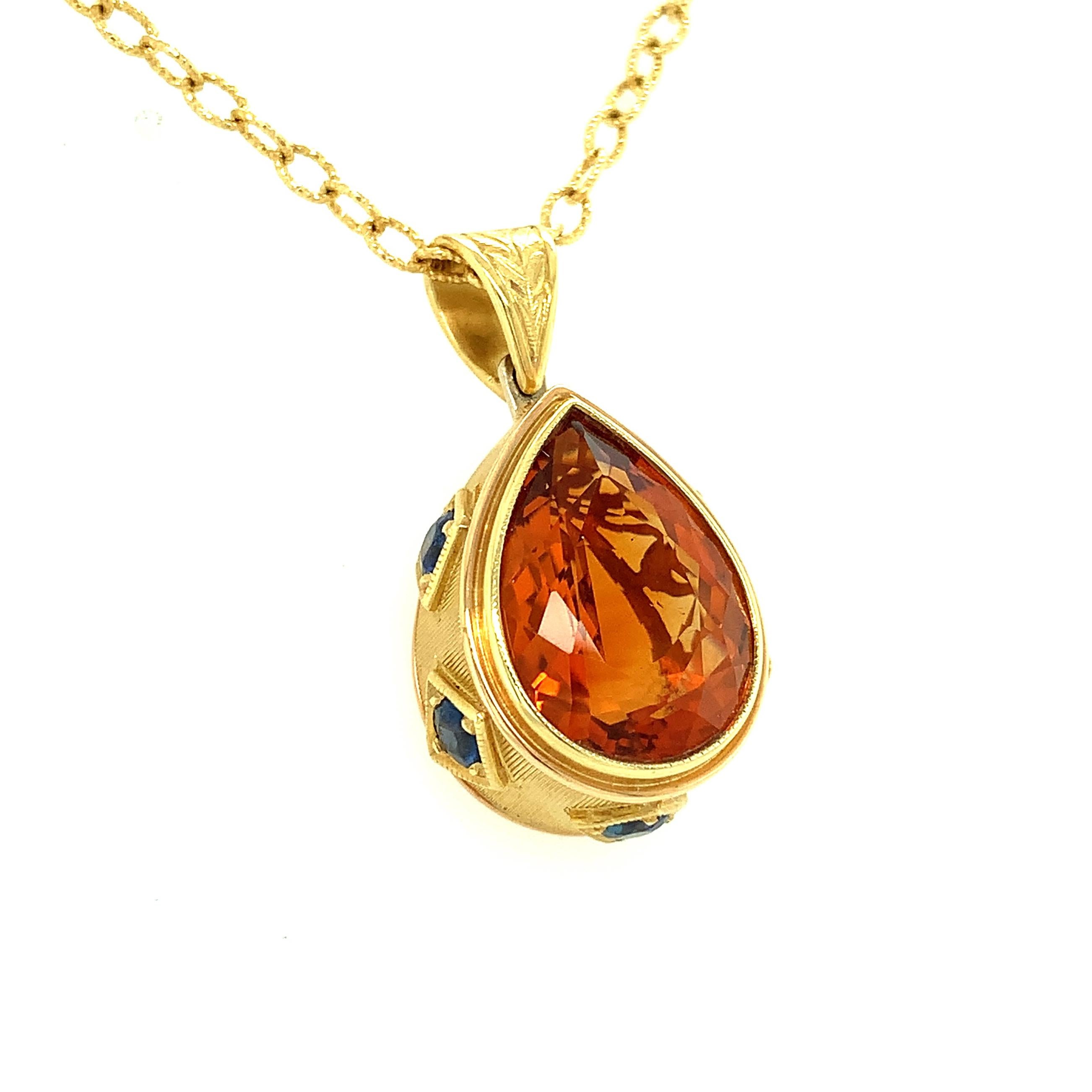 A rich, golden citrine and deep blue sapphires come together in this beautiful 18k pendant drop that has the presence and feel of an earlier time. The fine 