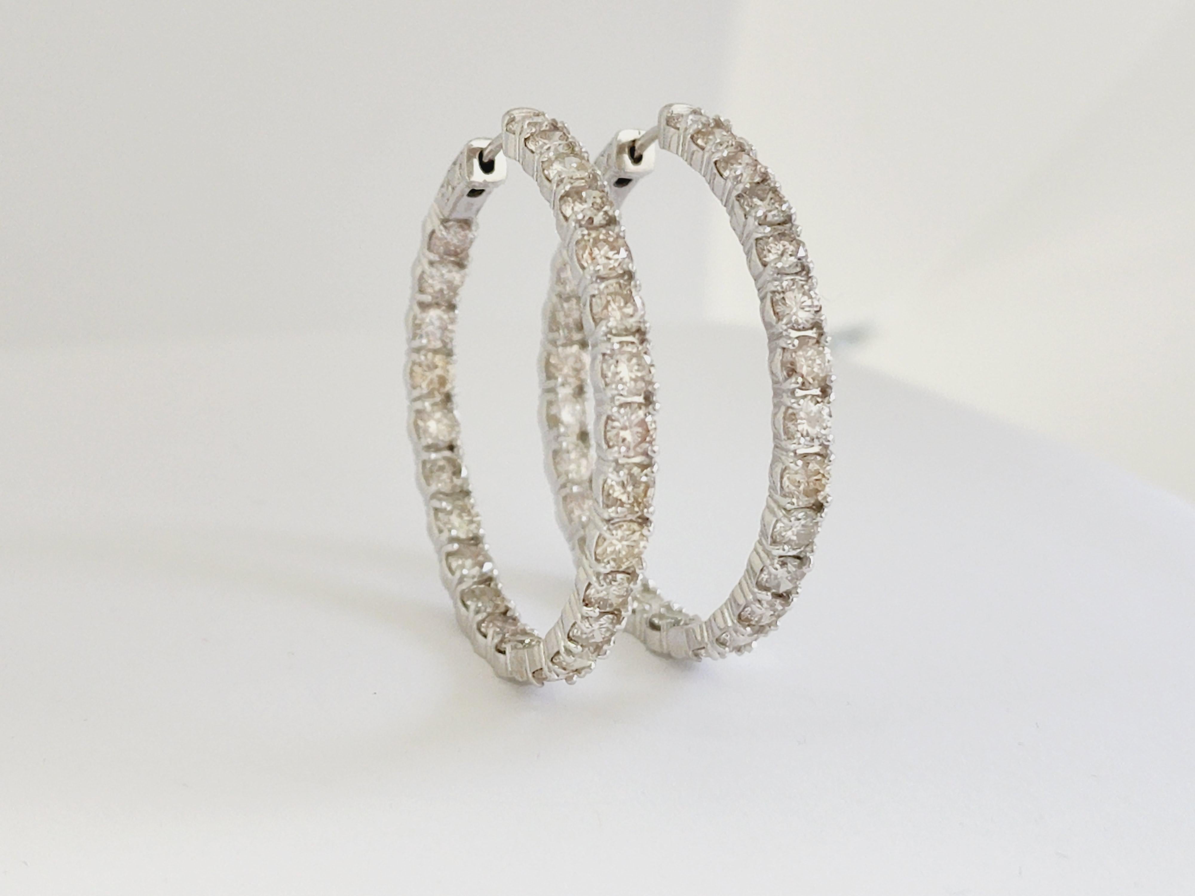 Beautiful pair of natural diamond inside out hoop earrings in 14k white gold. Secures with push snap closure. Very shiny and clean, average J-K, Color, SI Clarity,  Perfect for the everyday wear! Measures 1.50 inch diameter.