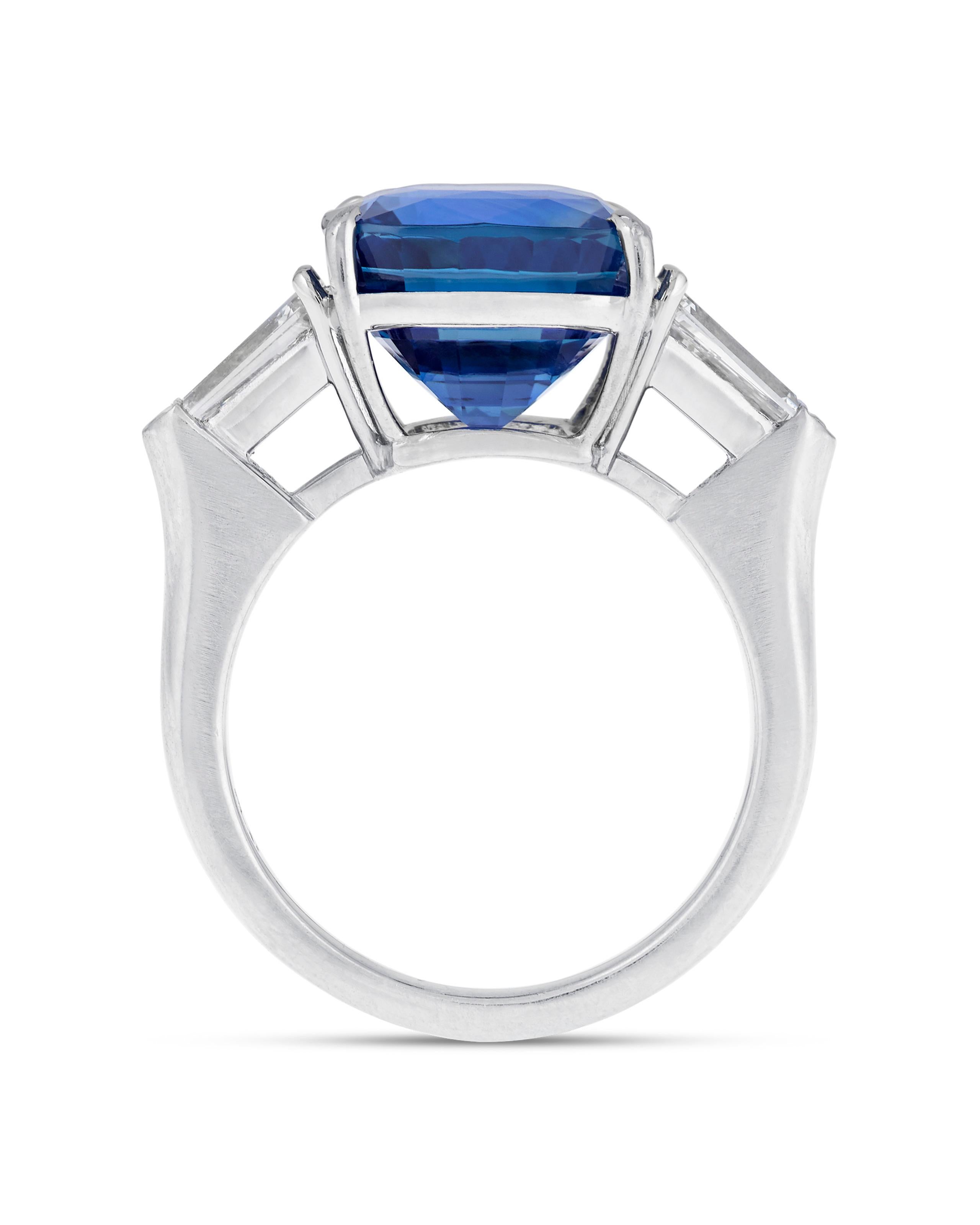 A dramatic sapphire weighing approximately 8.20 carats is set at the center of this classic ring. Exhibiting a deep royal blue color, the stunning gem is certified by the Gemological Institute of America (GIA) as being untreated, meaning it