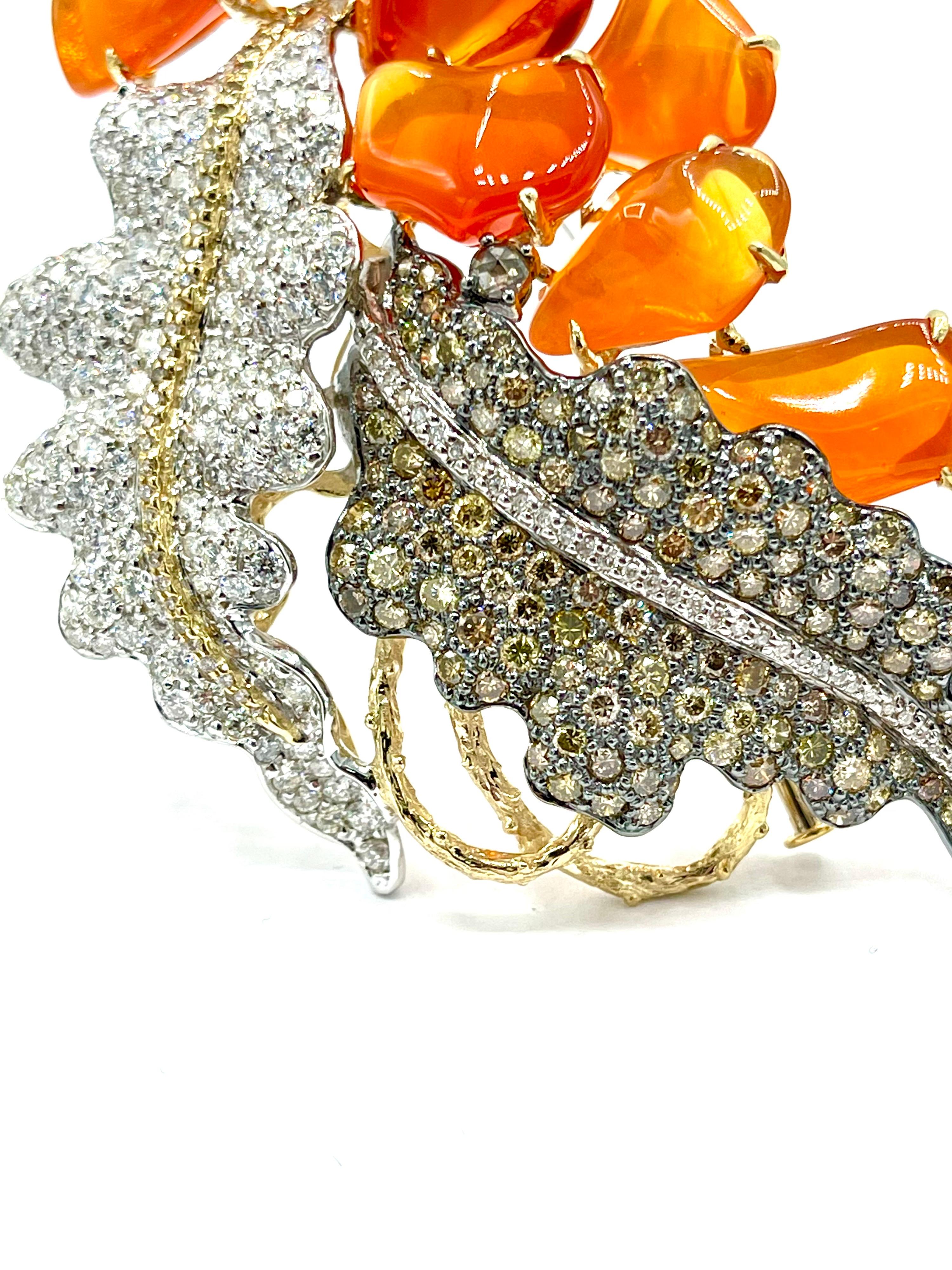 An amazing Diamond and Fire Opal pendant brooch!  The oxidized white gold leaf is pave set with a variety of colored fancy brown and fancy yellow toned round brilliant diamonds, with the polished white gold leaf pave set with round brilliant white
