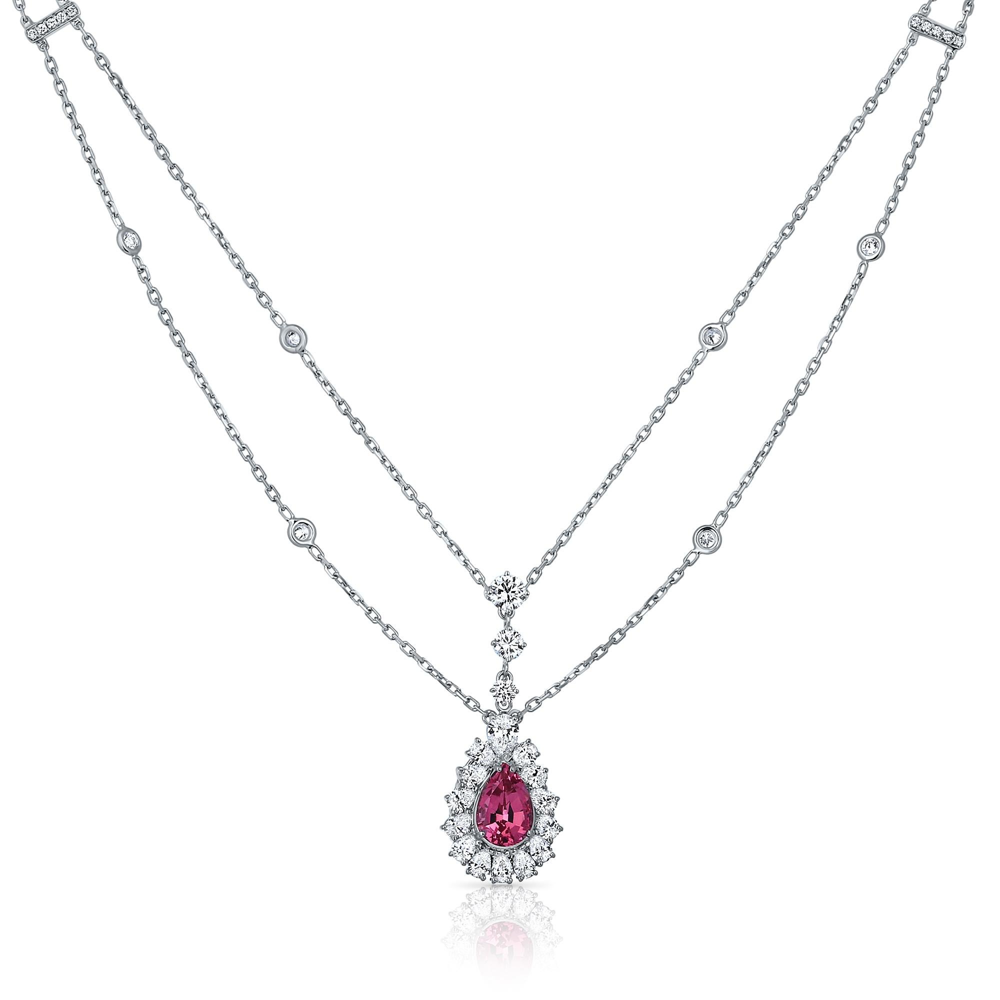 This fabulous antique style pendant is crafted from 18k white gold and features a rare pear-cut pink spinel gem stone at the center. The pink spinel adds extraordinary color and liveliness to this unique piece. You won't find anything quite like it!