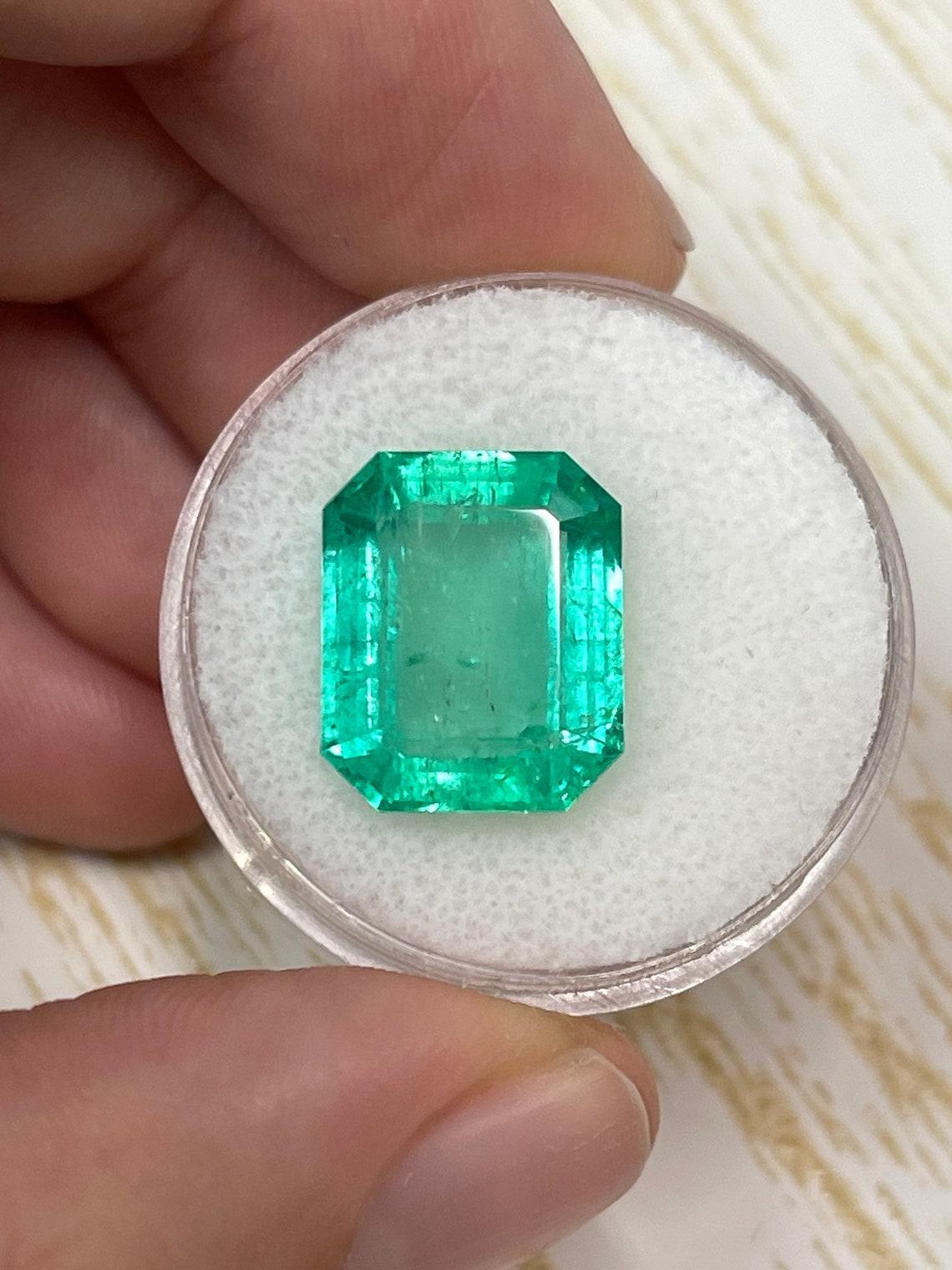 Stone: Emerald
Weight: 8.20-carats
Shape: Emerald Cut
Clarity: Transparent
Luster: Very Good
Color: Medium Green
Measurements: 14.00mm x 11.42mm x 6.35mm
Geographic Origin: Colombia
Treatment: Natural, Oiling

Comments: Due to their growth