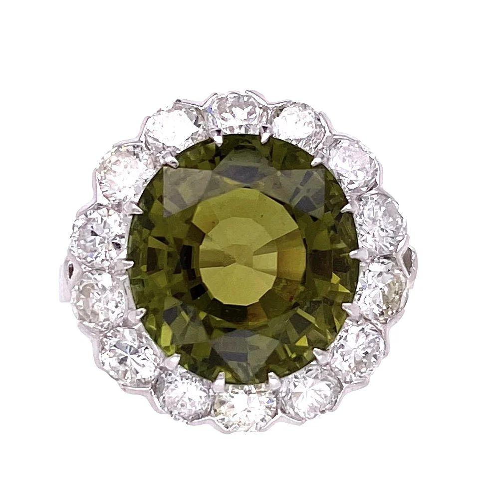 Simply Beautiful! Finely crafted Green Tourmaline and Diamond Vintage Art Deco Cocktail Ring. Centering a securely nestled Hand set 8.21 Carat Oval Green Tourmaline, surrounded by Diamonds, weighing approx. 1.68tcw. Hand crafted Platinum mounting.