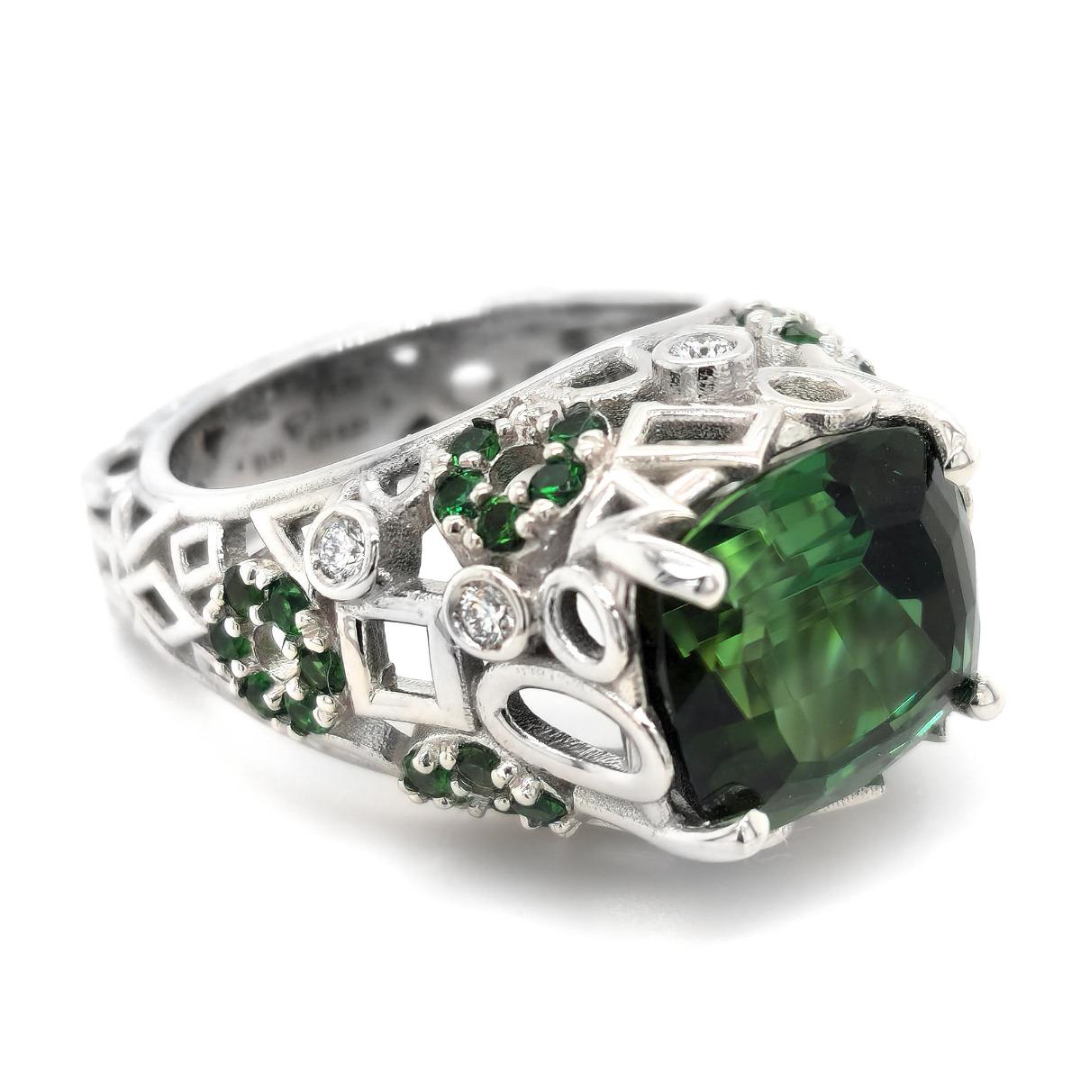 Tourmaline is known to symbolize friendship and wealth, and this 8.21 carat well crafted gemstone embodies just that. Cut as a cushion, the gemstones grandeur is brought to life. Perfectly matched diamonds and green tourmalines that compliment the