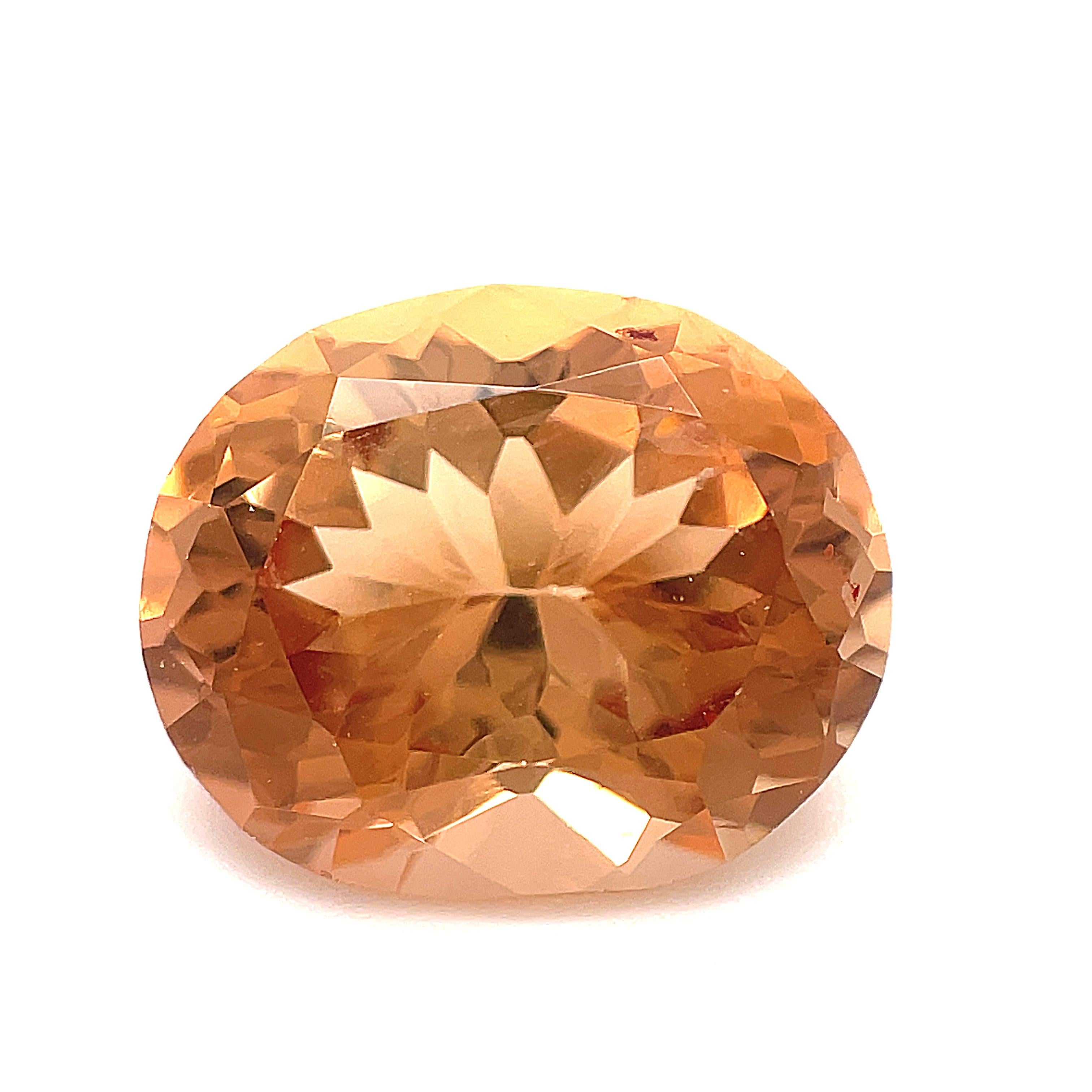 This beautiful 8.21 carat precious topaz oval is just stunning! With its lovely sparkling sherry color and exceptional brilliance, it will make a gorgeous ring or pendant! This precious topaz measures 13.46 x 11.12 carats and has a warm peachy color