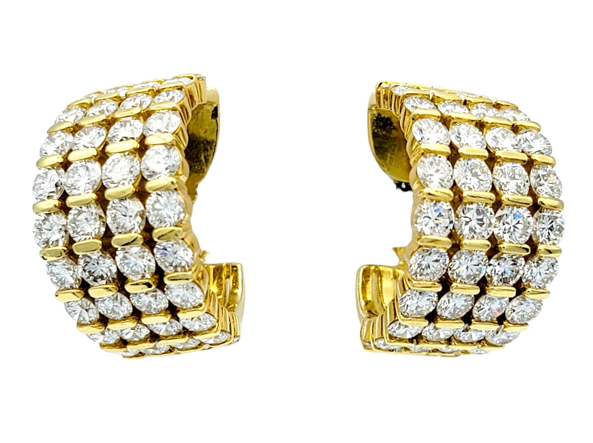 These exquisite diamond hoop earrings, set in lustrous 18 karat yellow gold, are a dazzling testament to elegance and sophistication. Each earring features four vertical rows of round diamonds, meticulously arranged to create a wide and sparkling