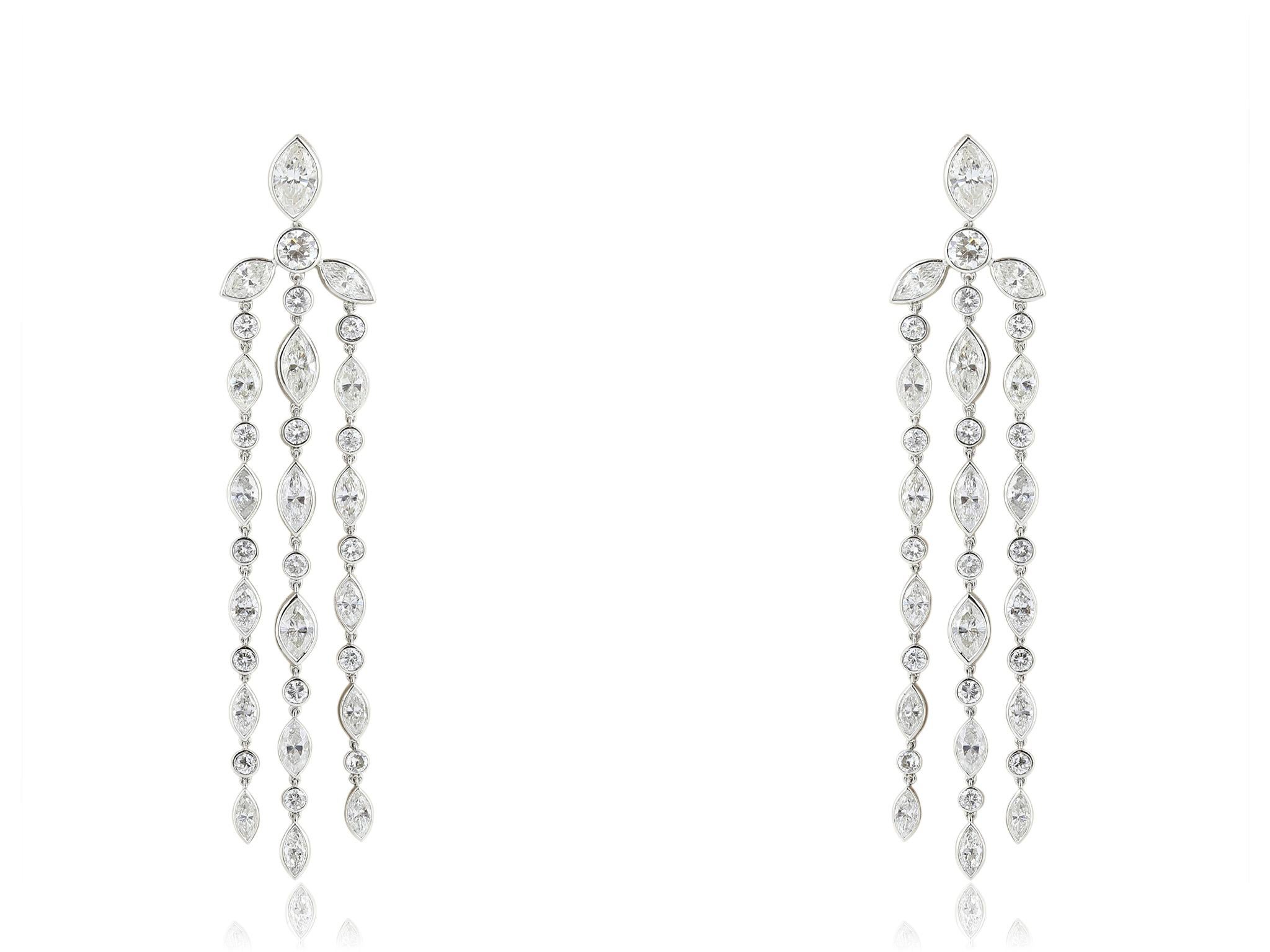 Stunning Art Deco platinum drop diamond earrings consisting of bezel set marquis and round brilliant cut diamonds with a total approximate weight of 8.25 carats with a color and clarity of F-G VS1-VS2 respectively.