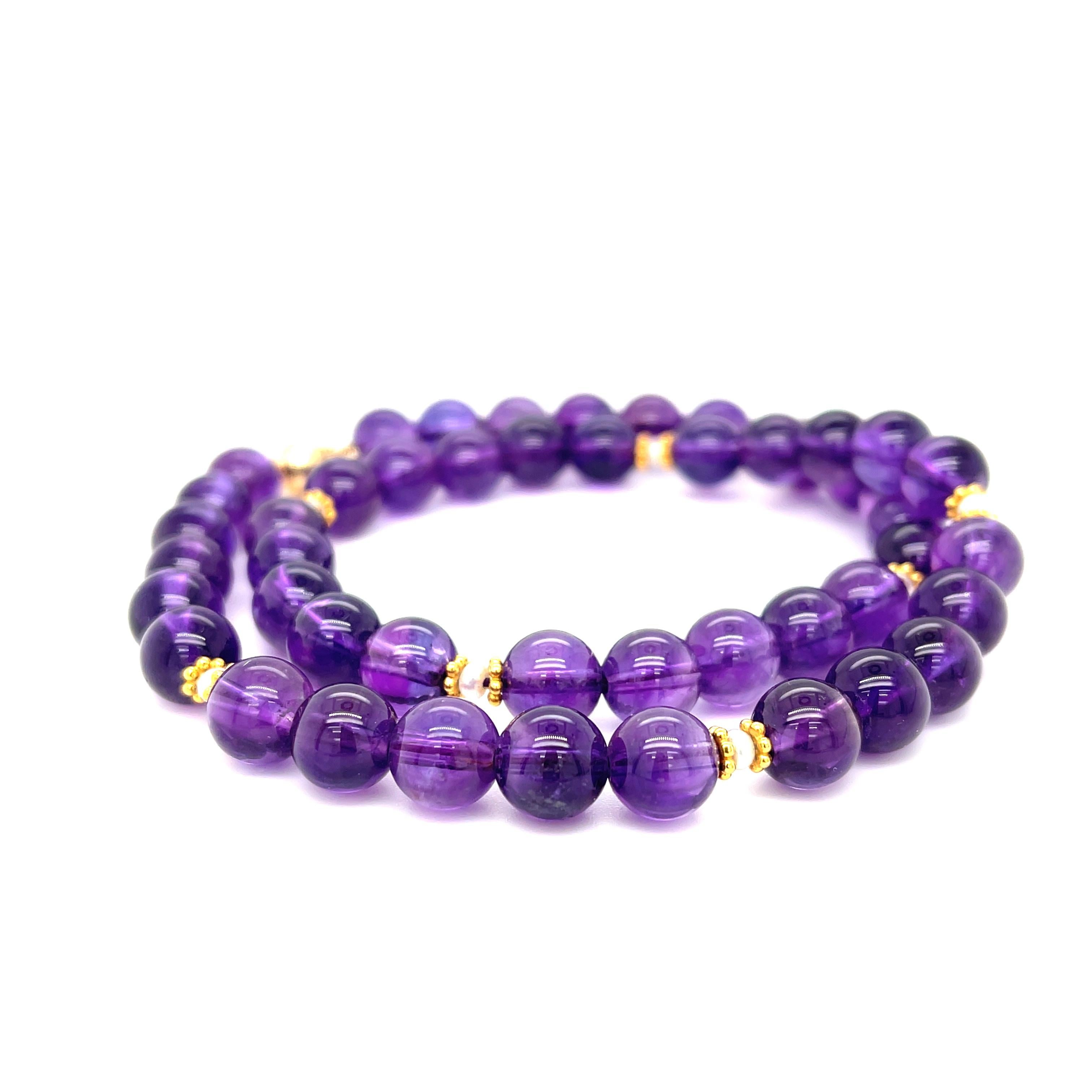 This richly colored amethyst bead necklace features gorgeous 8.25mm round amethyst beads that have been hand strung with delicate white seed pearls and 18k yellow gold beaded spacers. This combination of royal purple, gold, and pearls allow this