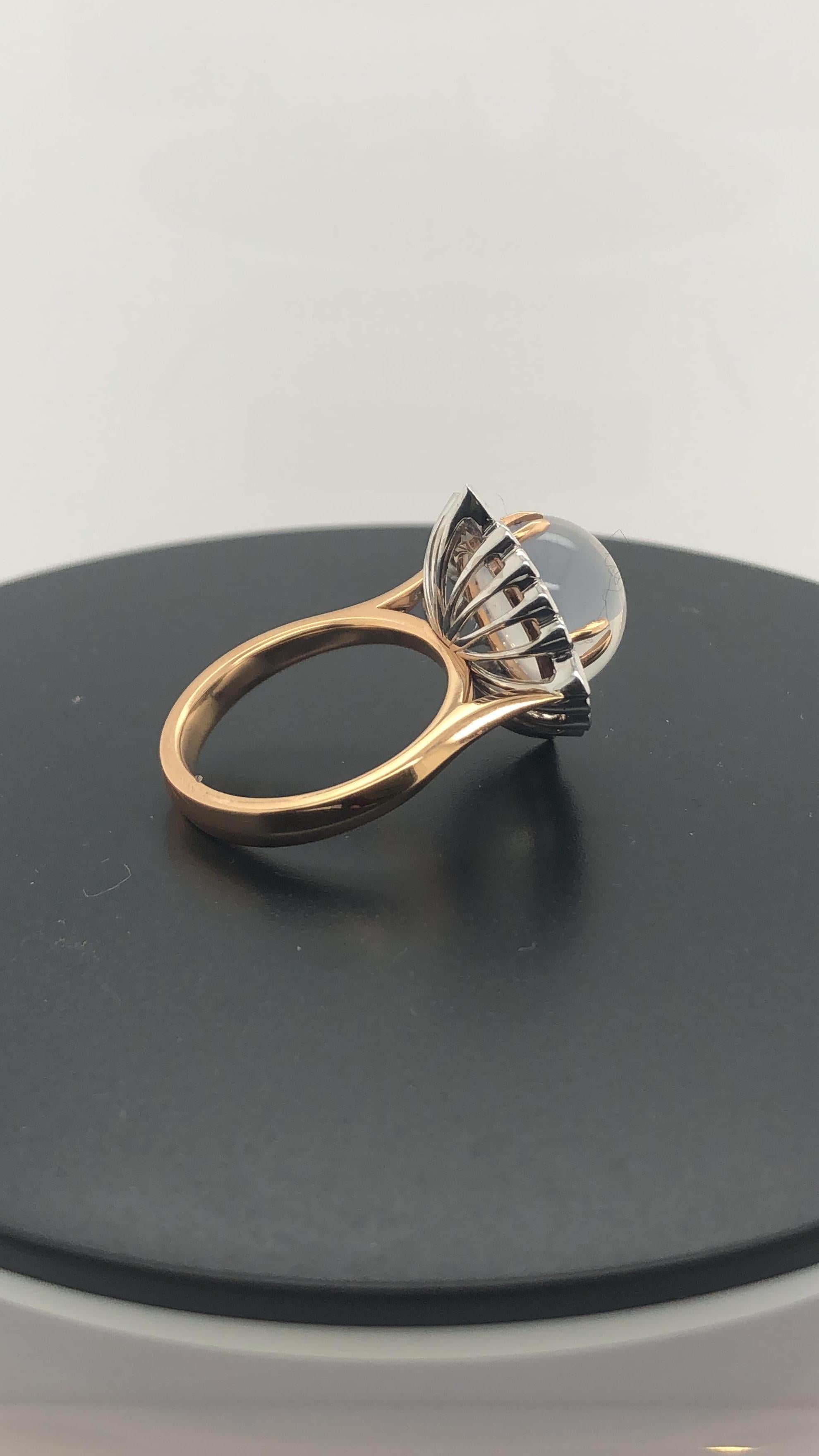 Hand Crafted 18 Carat Rose and White Gold Cocktail Ring, Set with 8.26 Carat Round Moonstone in 4 Split Rose Gold Talons, Surrounded by 20 Round Brilliant Cut and Pear Shaped Diamonds, weighing 0.85 Carats, F in Colour, VS in Clarity, in a Semi