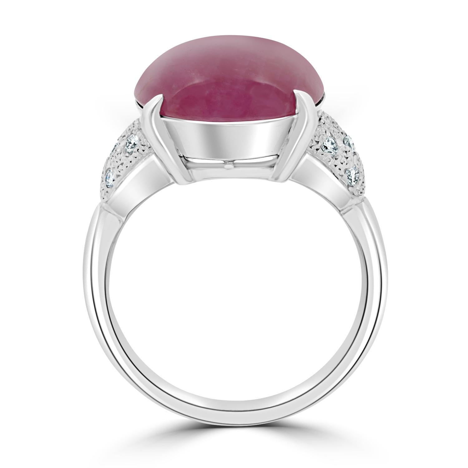 Designed from platinum, this elegant ring is set with an oval cut Star Ruby and surrounded by glittering Diamonds.
