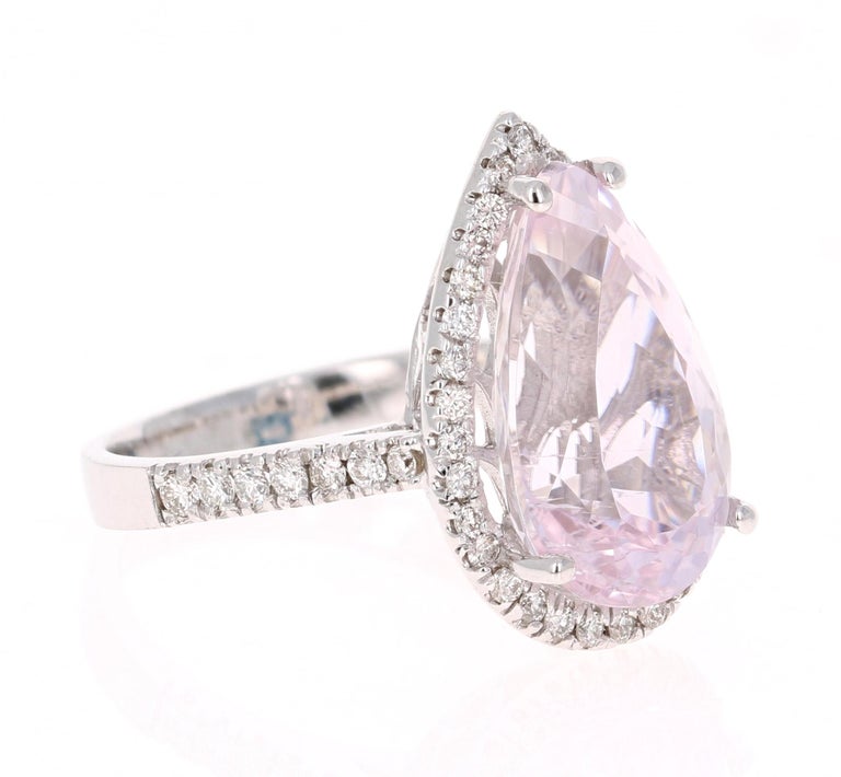 A lovely Engagement Ring Option or as an alternate to a Pink Diamond Ring! This simply stunning Kunzite Diamond Ring has a 7.78 Carat Pear Cut Kunzite as its center and has a beautiful simple halo of 46 Round Cut Diamonds that weigh 0.50 carats. The