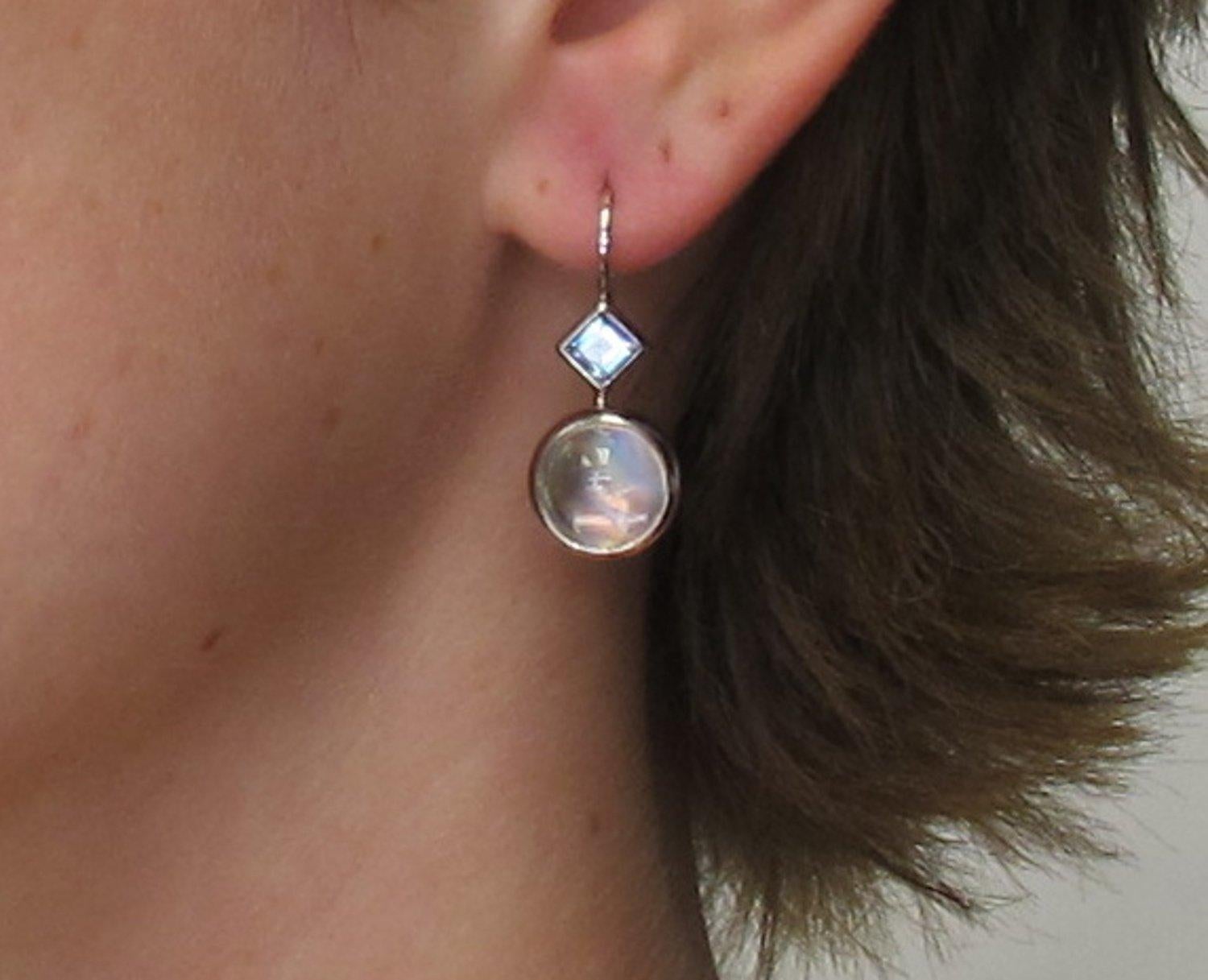 Simple and stunning! These earrings are a modern but  classic style everyone needs in their collection.  The mystical  moonstones (8.28 carats/total weight), pair beautifully  with two princess cut aquamarines (.66 carats/ total weight), picking up