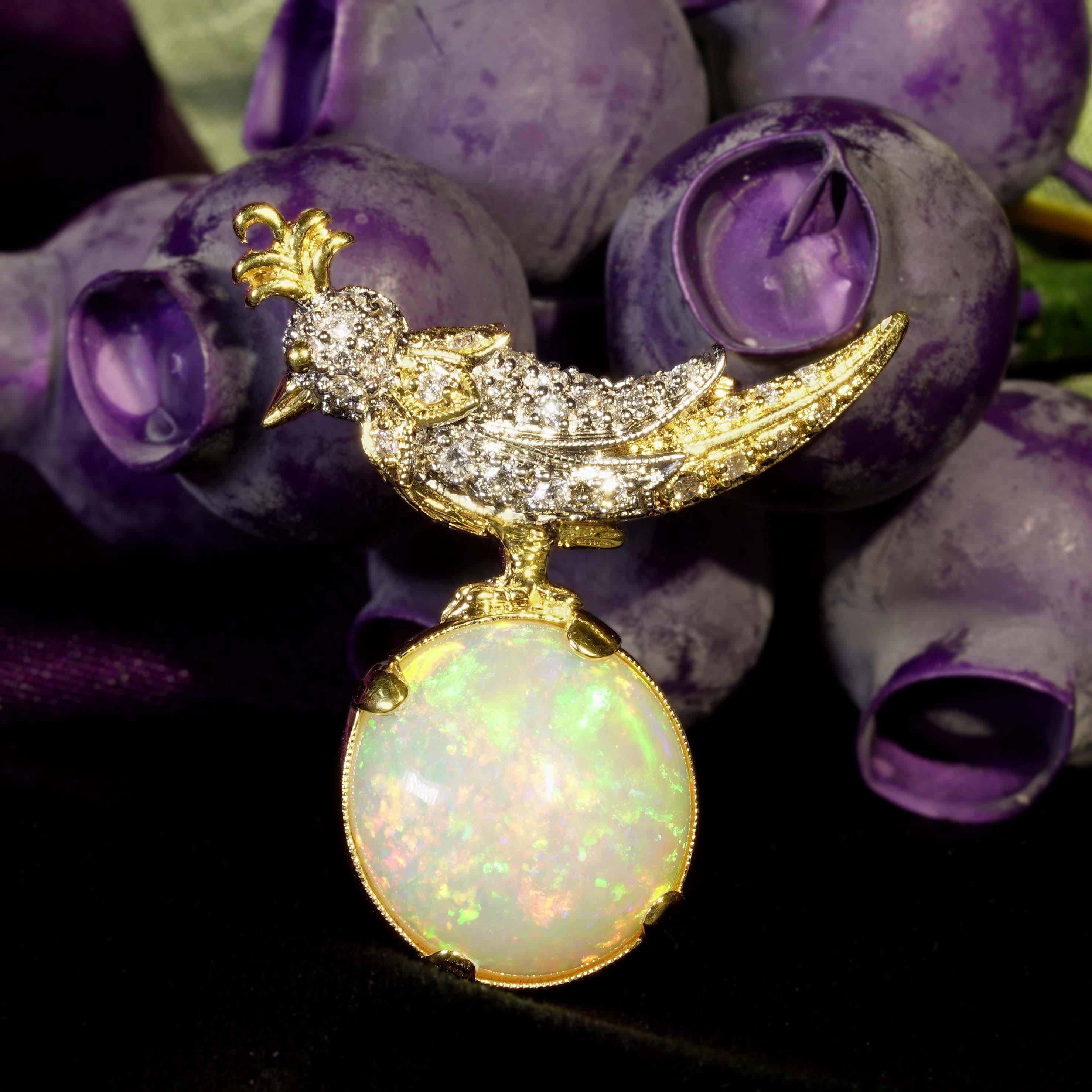 This incredible vintage style brooch depicts a gorgeous humming bird on a rock. It’s charming with an estimated 8.28 carat Ethiopian opal for the rock and total of 0.52 carat sparkling diamond encrusted along the head and body of the lovely humming
