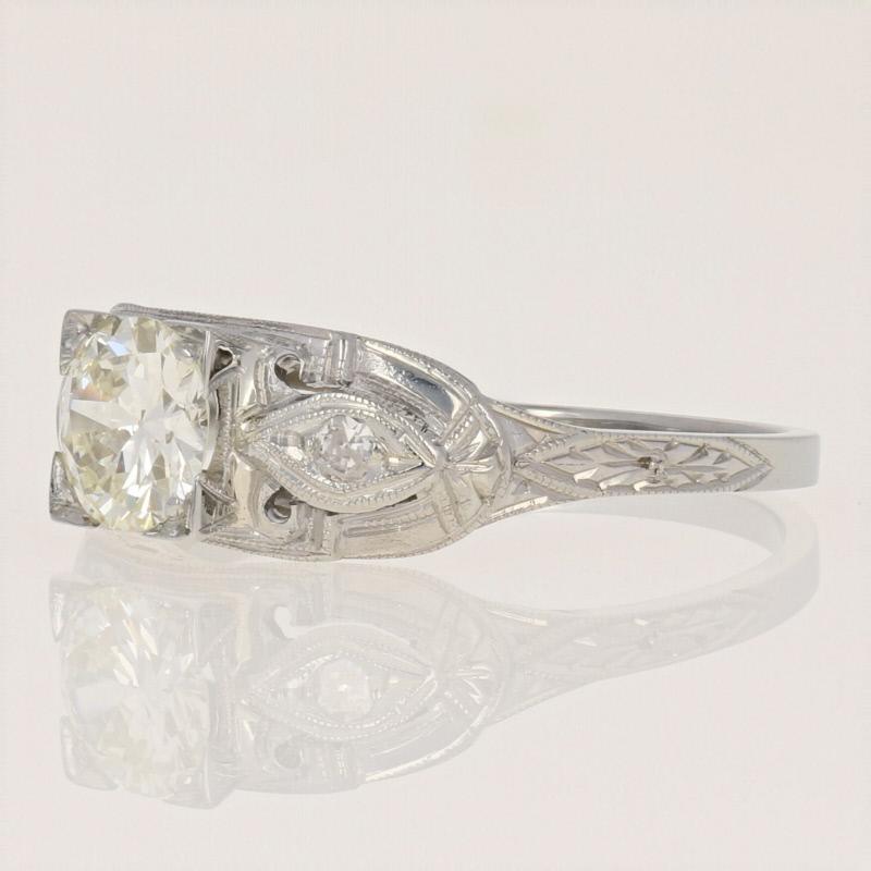 Pure Art Deco allure! Dating back to the 1920s - 1930s, this stunning vintage ring showcases an European cut diamond solitaire accompanied by two single cut diamond accents which are featured in a 14k white gold mount graced with open cut details,