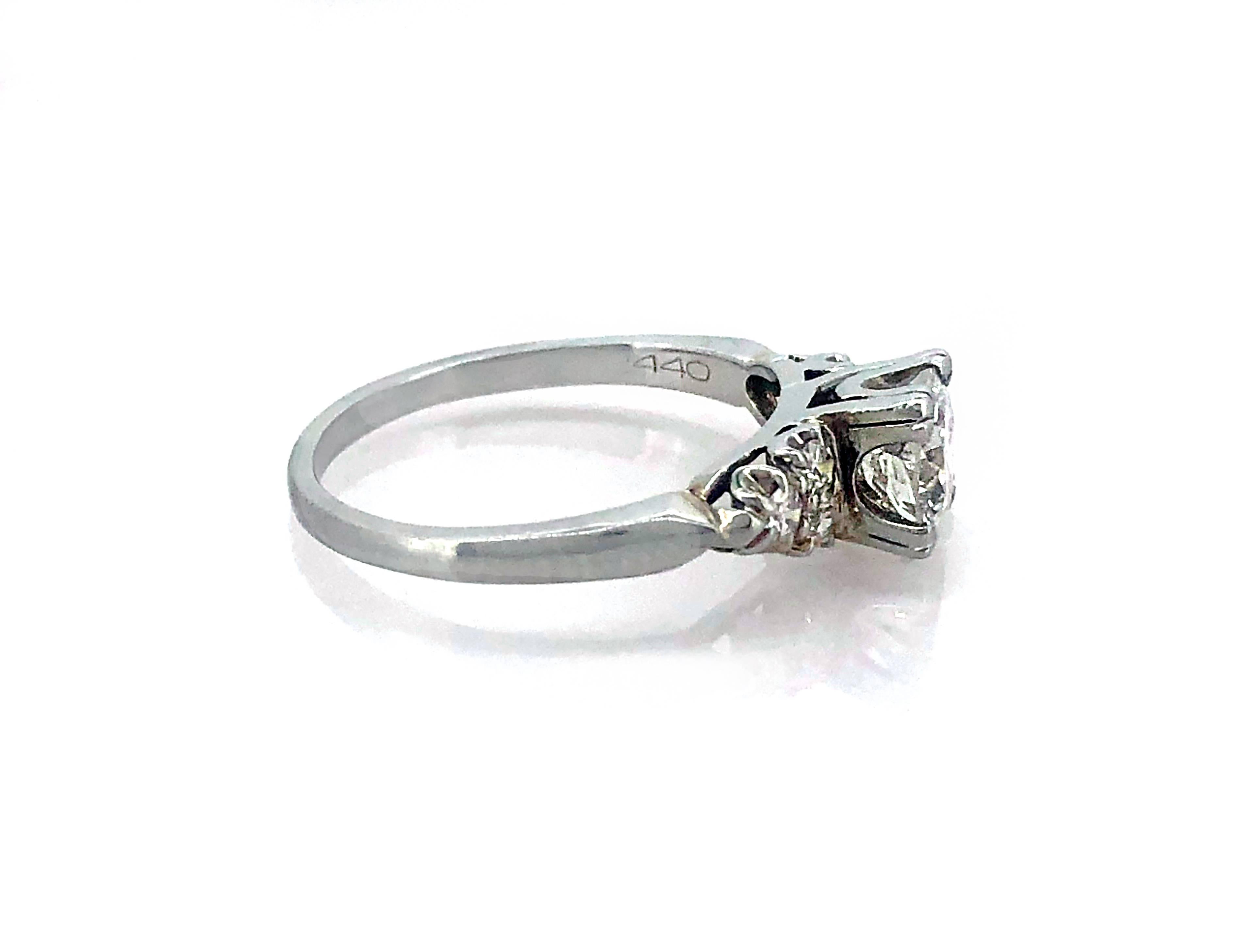 A classic Art Deco diamond Antique engagement ring which is crafted in 18k White Gold and features a .83ct. apx. Transitional cut diamond with SI3 clarity (100% Eye Clean) and G color. The center diamond is accented with .25ct. apx. T.W. of single