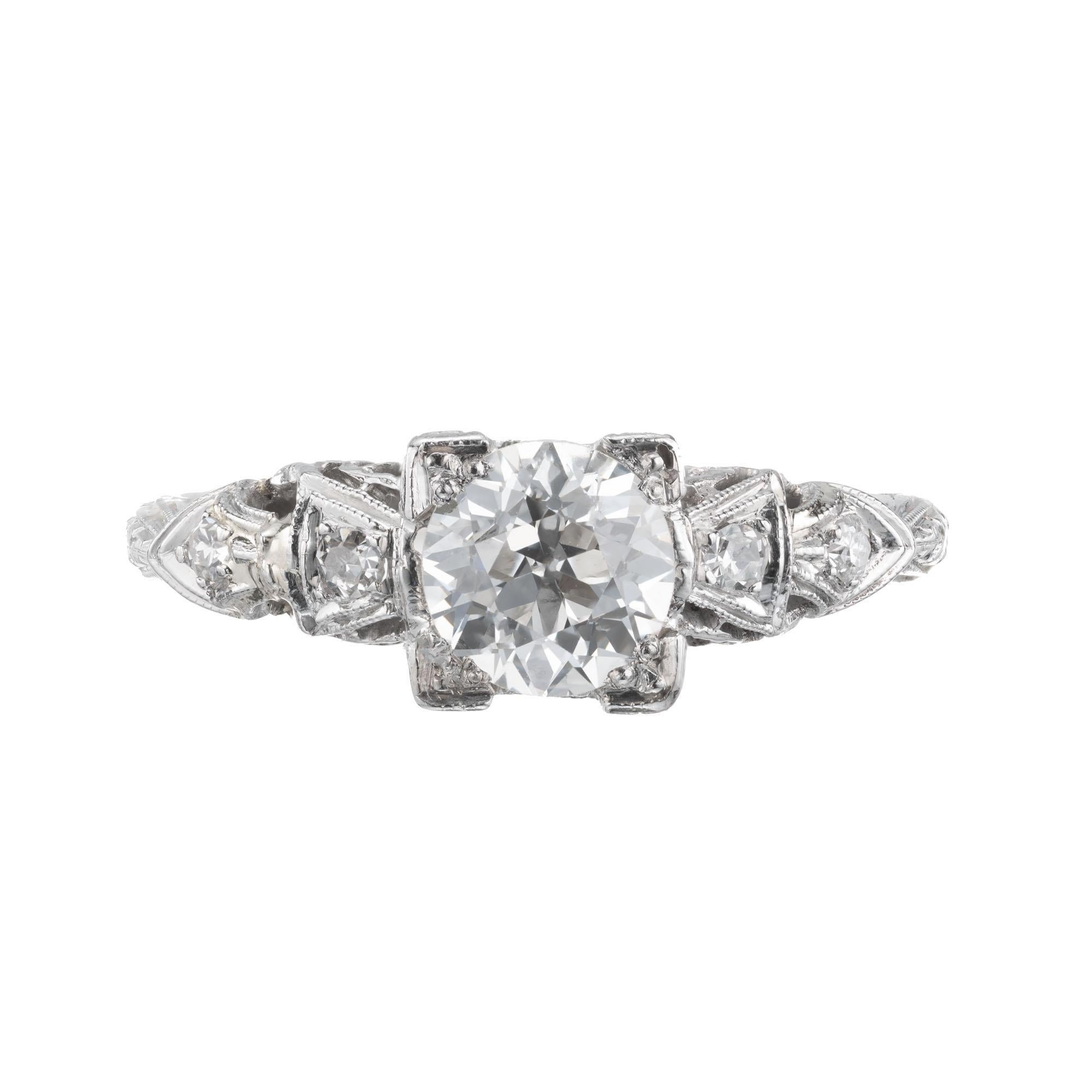 Art Deco filigree diamond platinum engagement ring. One round center diamond with 4 single cut accent diamonds. 1920-1929. 

1 old European cut diamond, approx. total weight .83cts, G – H, VS1, 
4 single cut diamonds, approx. total weight .08cts, G