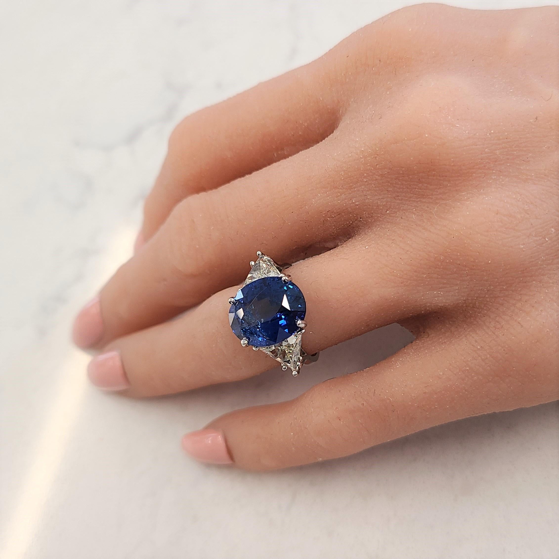 This expertly crafted brightly polished platinum 3-stone past, present, and future ring is the perfect selection for those who love a bold, statement style. This lavish ring features one oval cut, fine quality vibrant blue sapphire prong set in the