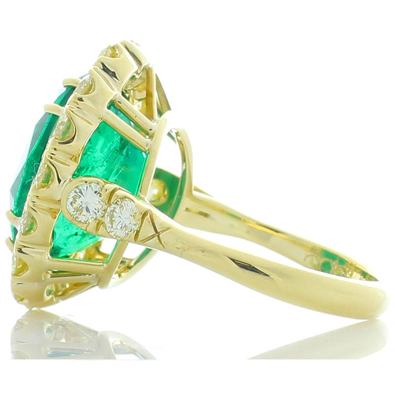 This ring features a spectacular 8.30 carat oval cut emerald. It measures 14.32 x 11.07 mm and exhibits show-stopping color and brilliance. Its origin is Zambia, its color is bright grass green. In addition to its size, the transparency and clarity