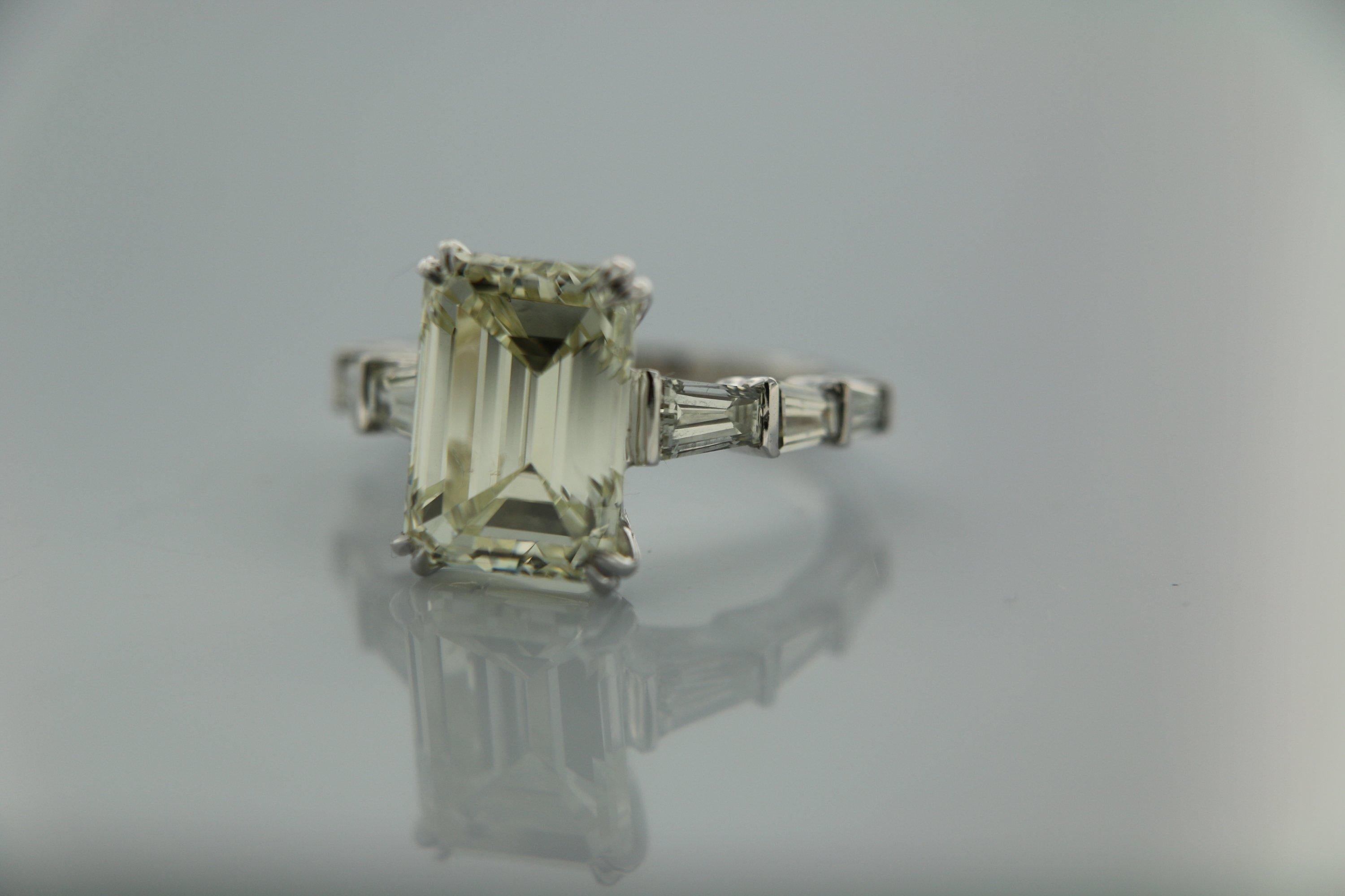 Contemporary 8.31 Carat Emerald cut White Diamond And Baguette Ring In 18K Gold.  For Sale