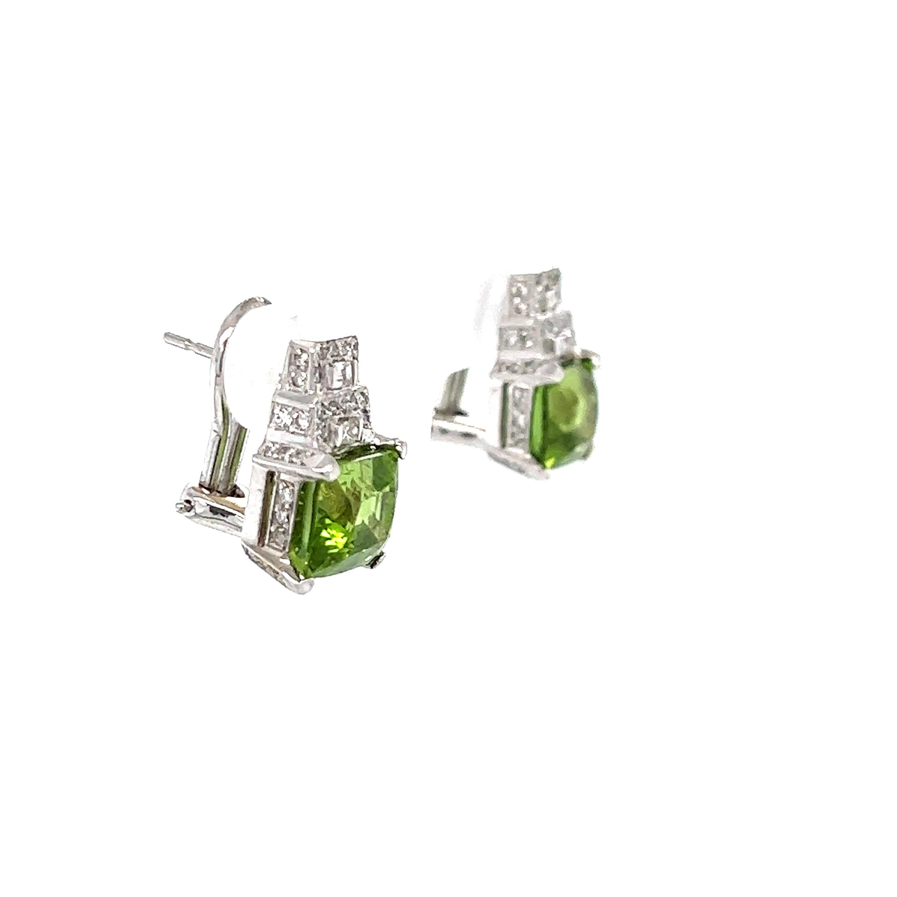 There are 2 Square Cushion Cut Peridots that weigh 7.70 carats and measure at 8 x 9 mm each. 

There are 78 Round Cut Diamonds that weigh 0.46 carats and 4 Baguette Cut Diamonds that weigh 0.15 carats. Clarity and Color of the Round Cut Diamonds are