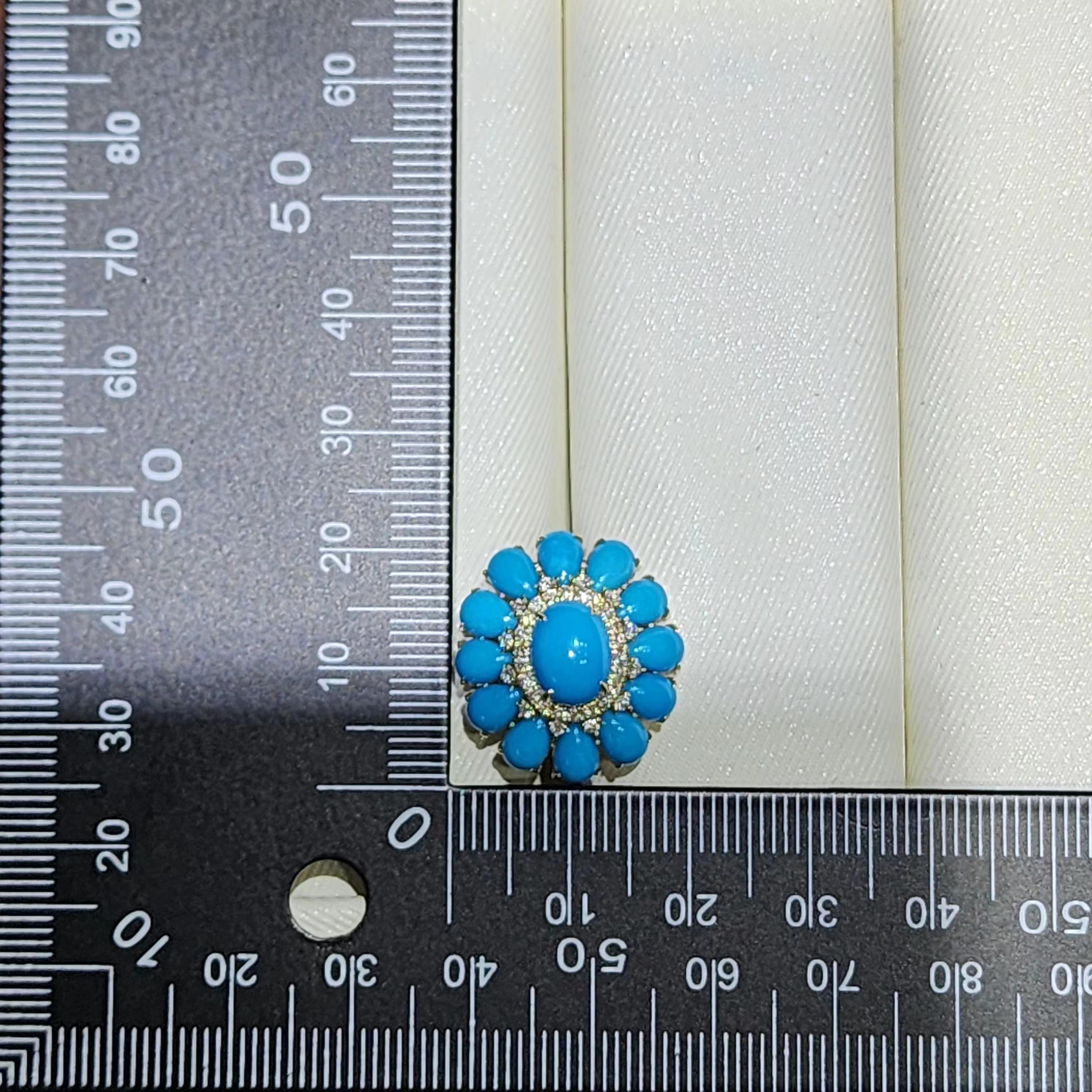 This striking 14k yellow gold ring is a celebration of vibrant color and timeless elegance. The centerpiece features a bold 3.39 carat turquoise cabochon, surrounded by an array of additional turquoise stones, totaling 4.92 carats. The captivating