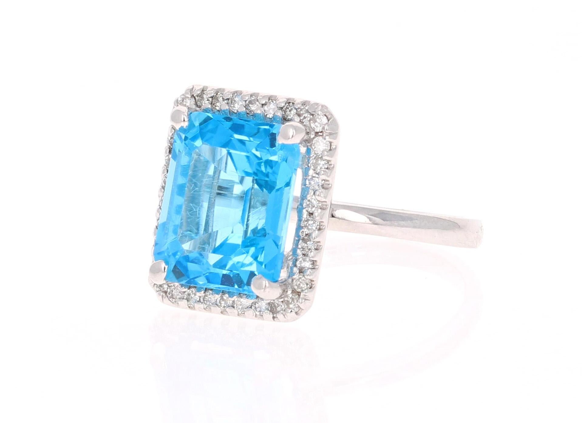 This beautiful Emerald cut Blue Topaz and Diamond ring has a stunningly large Blue Topaz that weighs 7.98 Carats. It is surrounded by 34 Round Cut Diamonds that weigh 0.34 Carats. The total carat weight of the ring is 8.32 Carats. 
The setting is