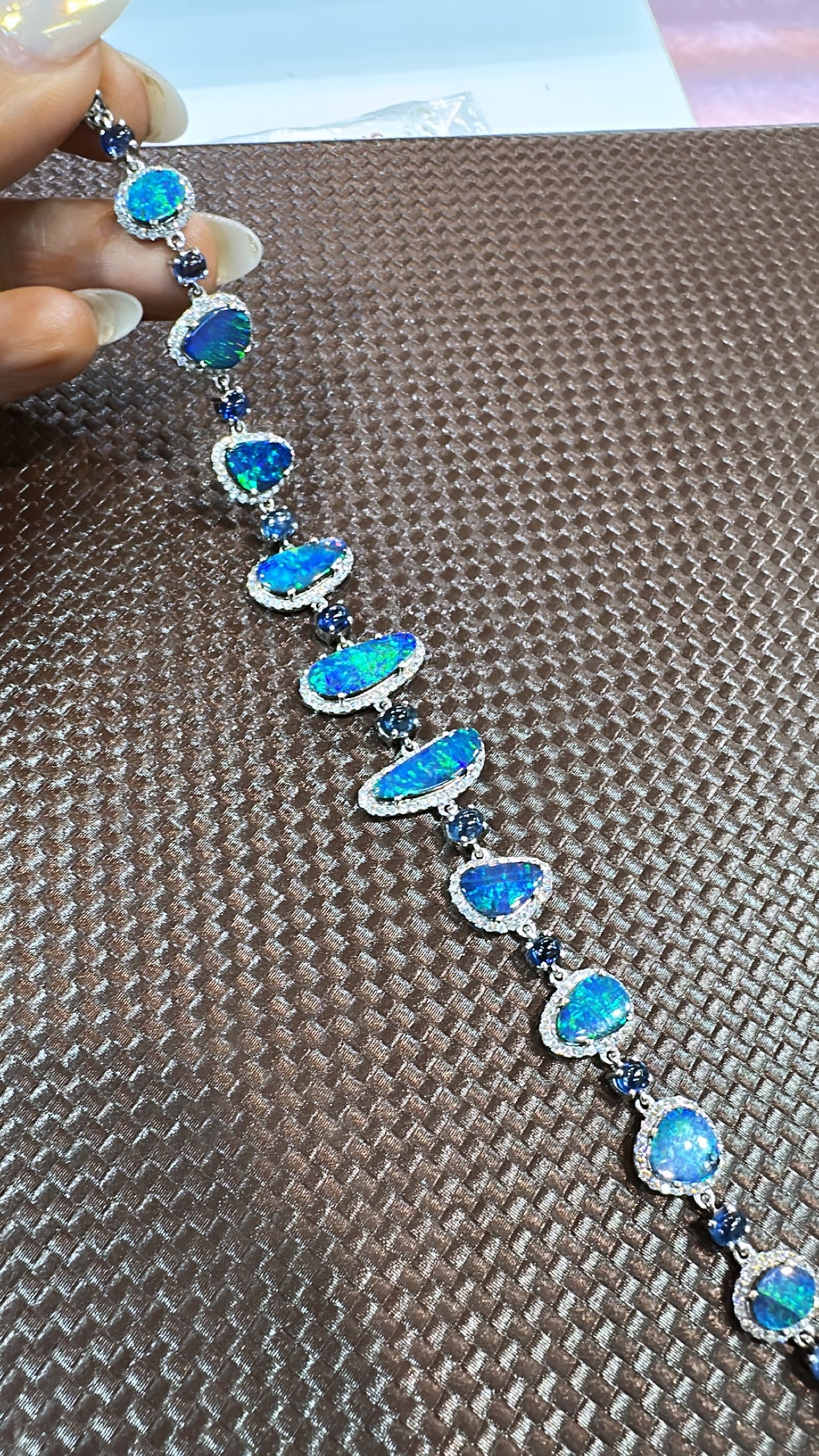 A very gorgeous, fun yet classic Doublet Opal and Blue Sapphire Tennis Bracelet set in 18K Yellow Gold & Diamonds. The  weight of the doublet Opal is 8.33 carats. The weight of the Blue Sapphires is 5.04 Carat. The Blue Sapphire cabochons are