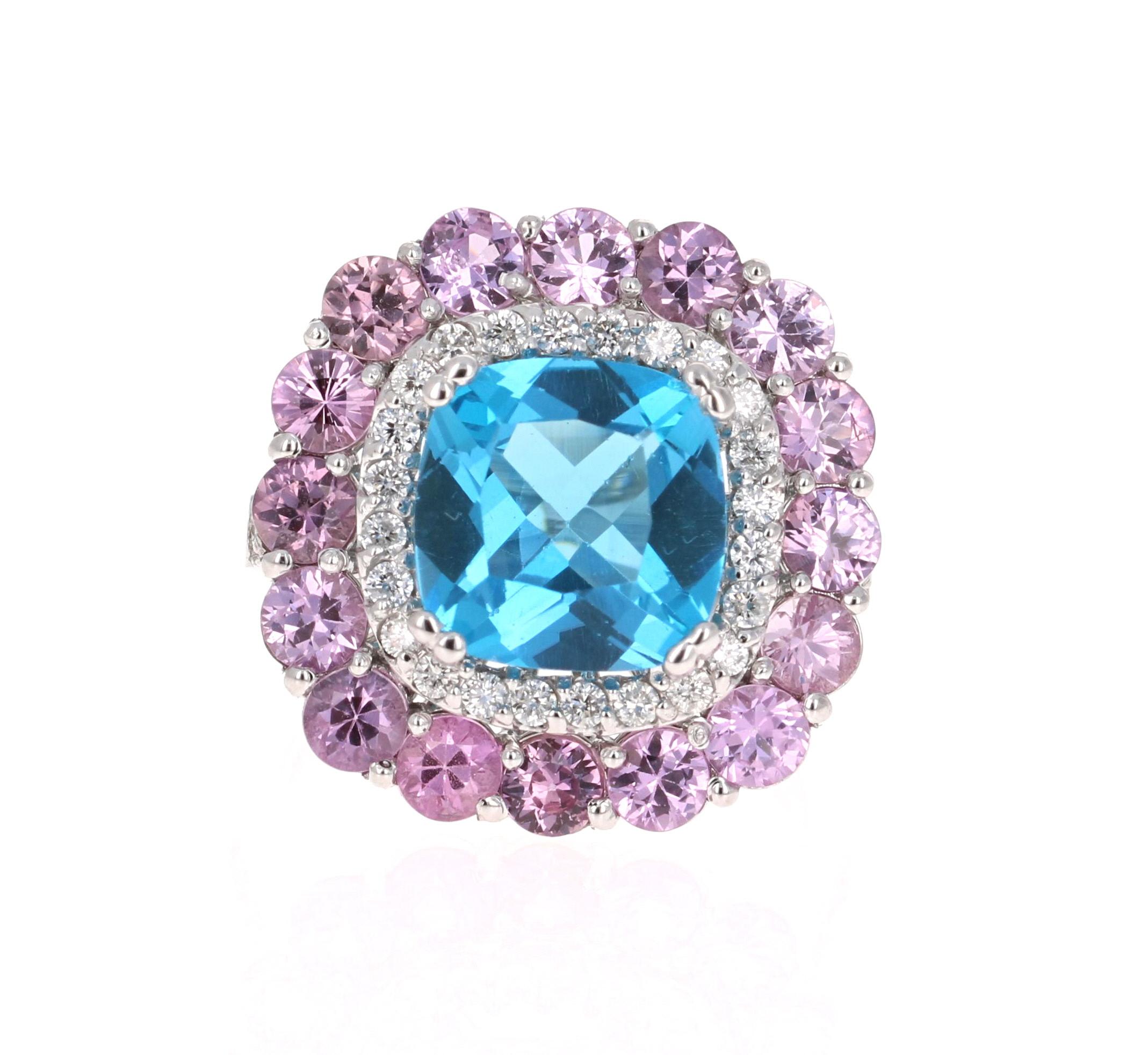 Beautiful to say the Least! 

This Ring has a magnificent Cushion Cut Blue Topaz that weighs 4.71 carats and is surrounded by 19 Round Cut Pink Sapphires that weigh 3.13 carats and 38 Round Cut Diamonds that weigh 0.50 Carats (Clarity: SI, Color: