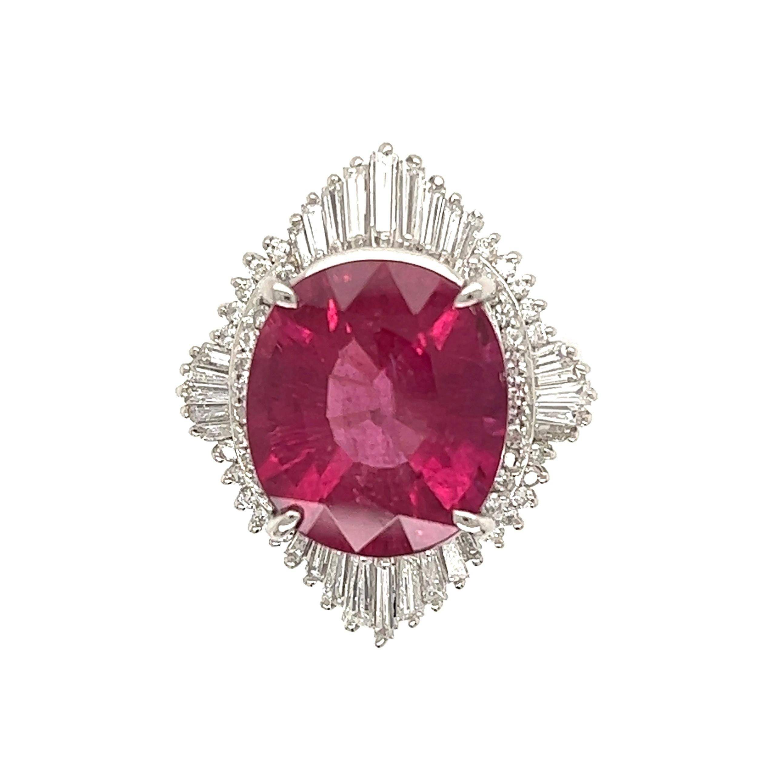 Simply Beautiful! Finely crafted Rubelite Cocktail ring, center securely set with a 8.34 Carat Rubelite Tourmaline, surrounded by round and baguette Diamonds, weighing approx. 1.01tcw. Hand crafted Platinum mounting. Approx. Dimensions: 1.07” l x