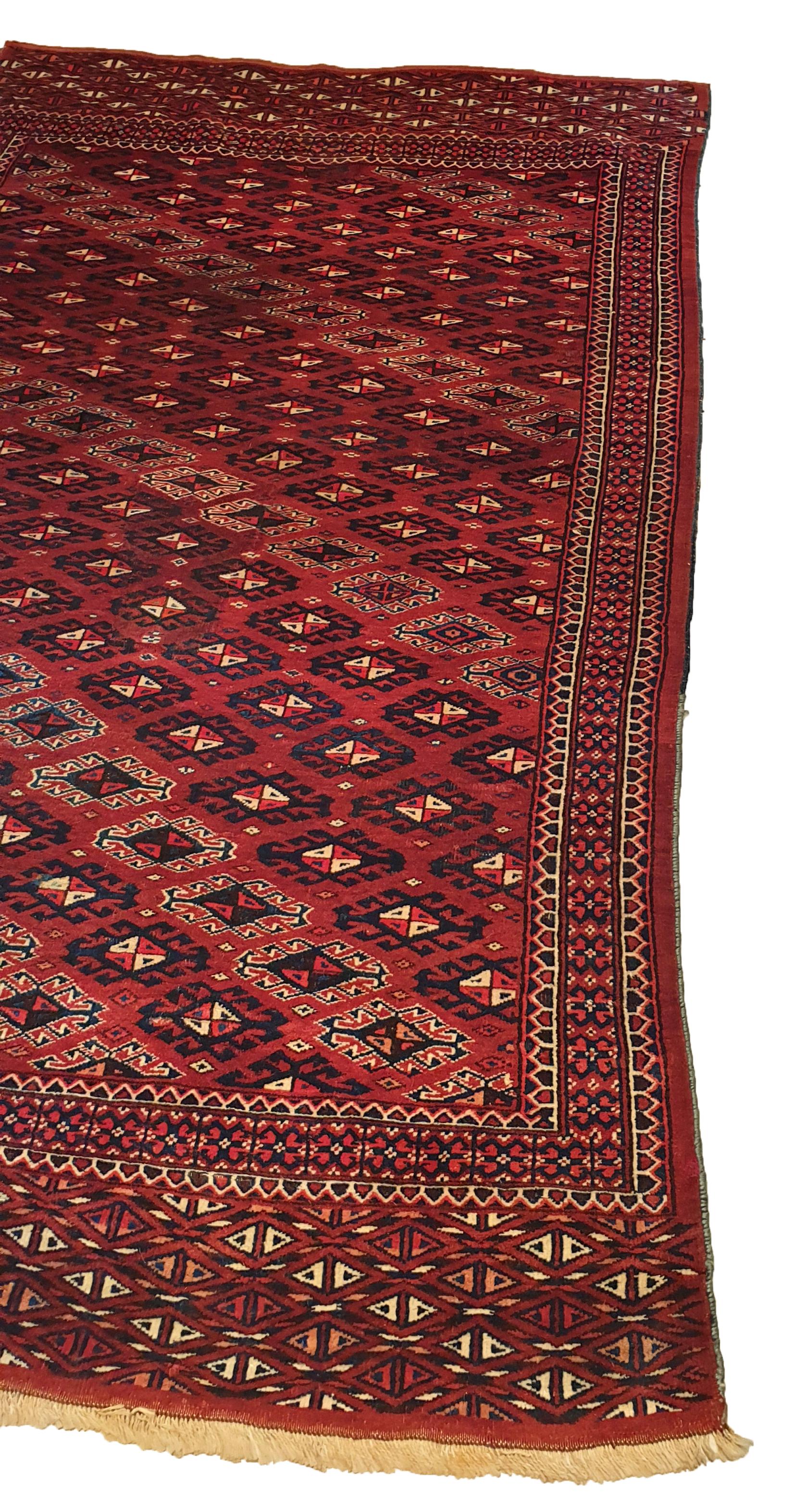 834 - very beautiful Turkmen carpet from the end of the 20th century with a nice Bukhara pattern with a beautiful Bukhara Guls and geometric design, and beautiful colors with red, orange, dark blue, green and black, entirely and finely hand-knotted
