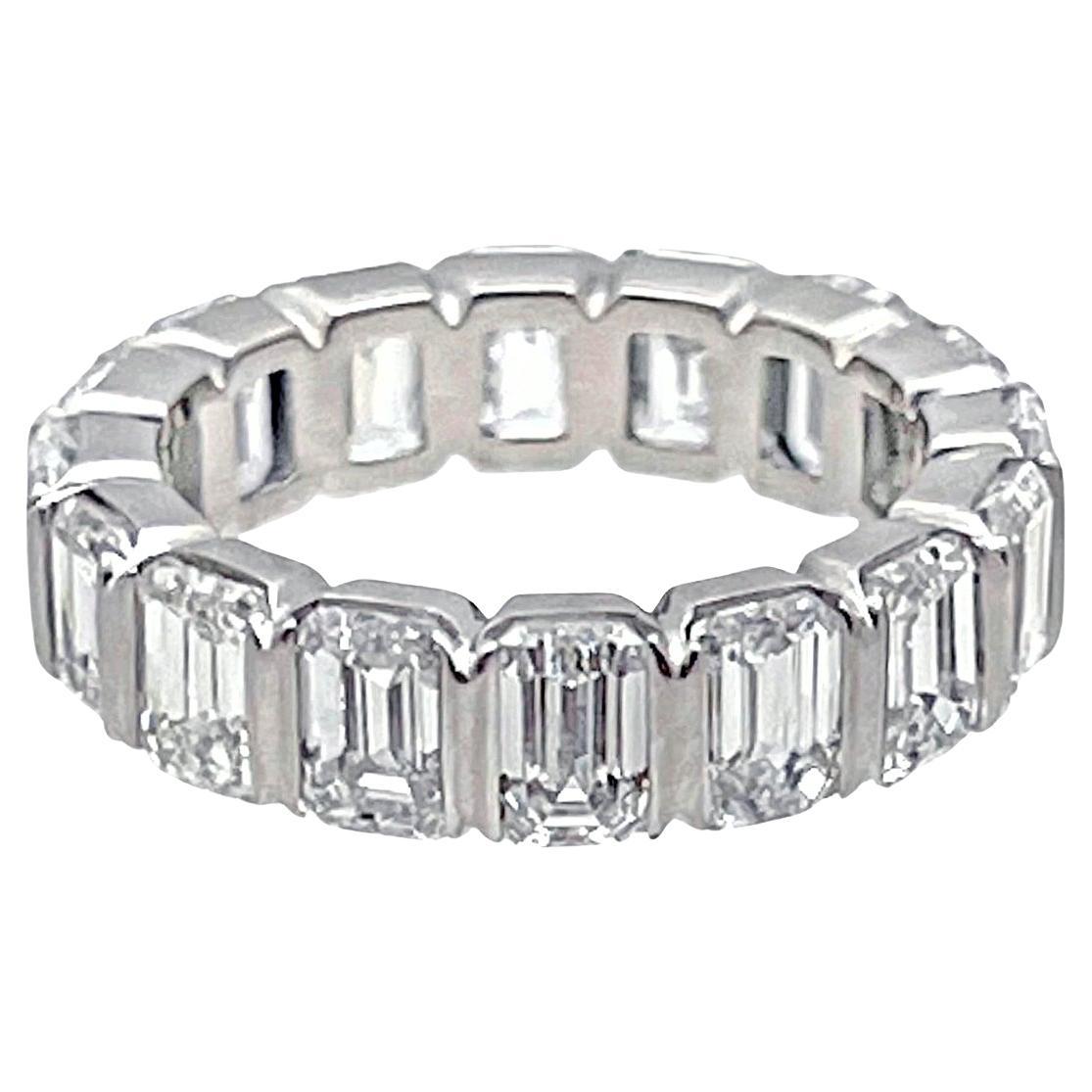 Emerald-cut diamond eternity band ring, featuring sixteen fine colorless emerald-cut diamonds weighing 8.35 total carats, mounted in a shared-prong platinum setting. 
Diamonds are E color and VS1-VS2 clarity.  Size 7.5.