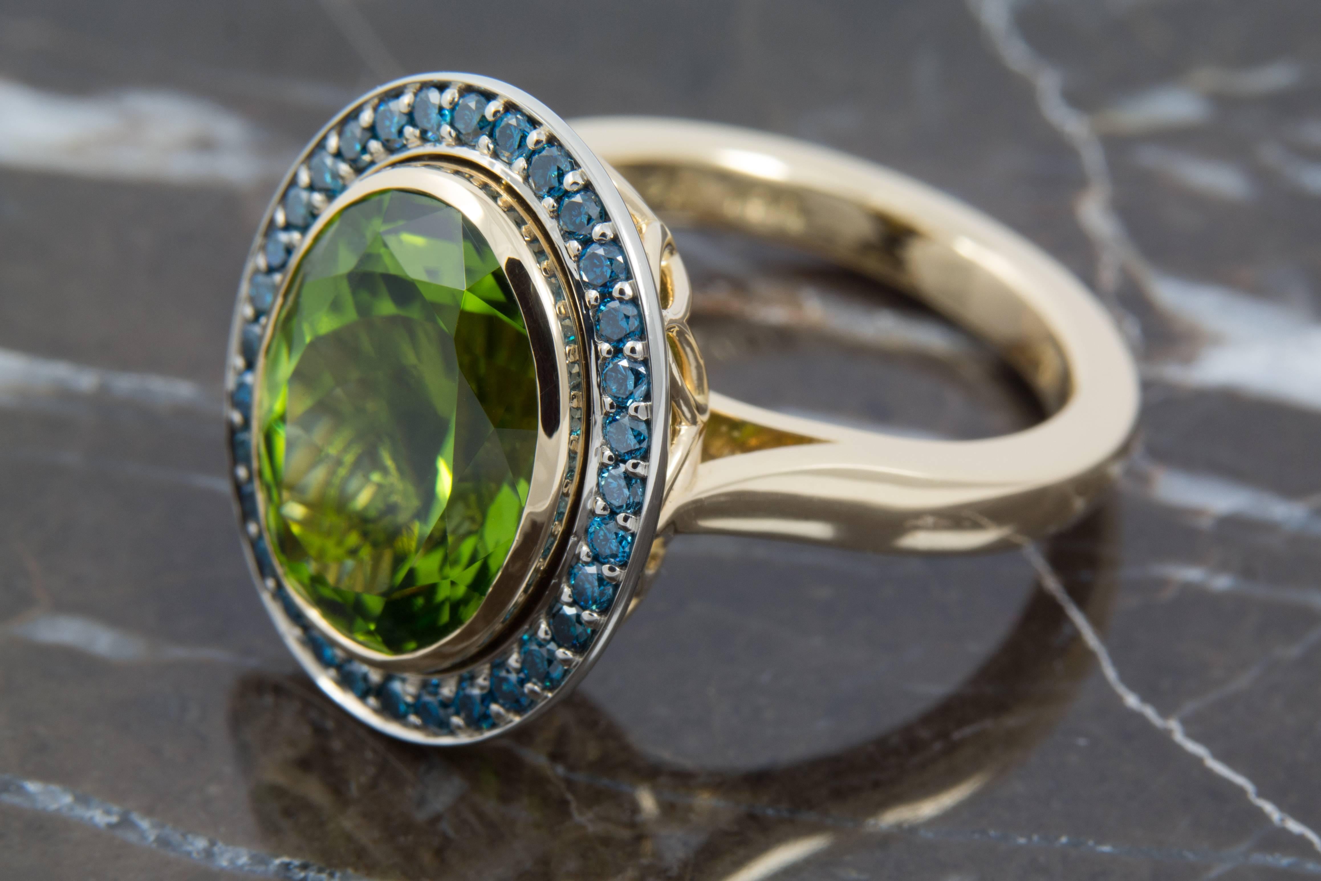 Contemporary 8.35 Carat Peridot and Blue Diamond Halo Cocktail Ring set in 18 Karat Gold