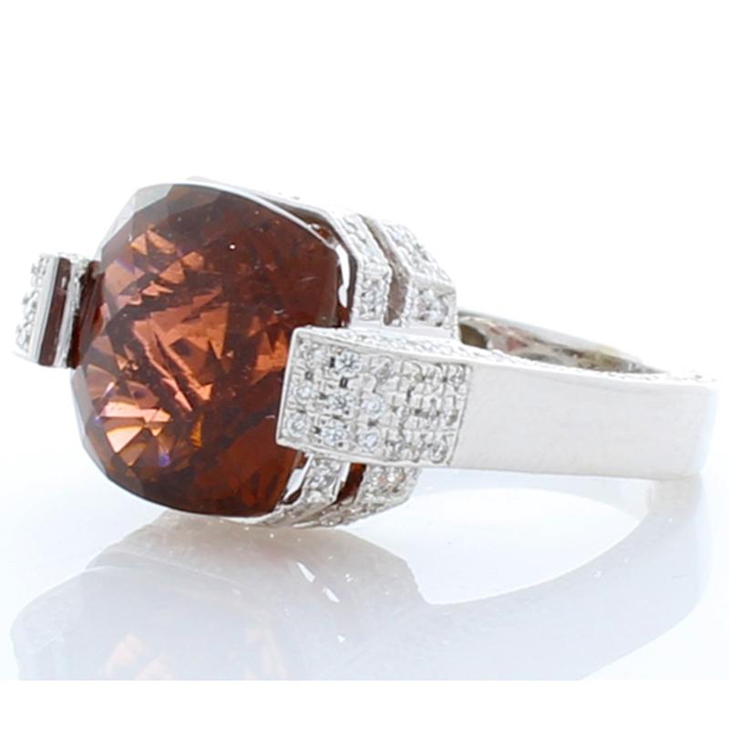 This striking vibrant custom made cocktail ring features a cushion cut deep fine quality orange tourmaline with a weight of 8.37 carats and has measurements of 11.92mm X 11.54mm. Sparkling round brilliant cut diamonds are micro pave set in a