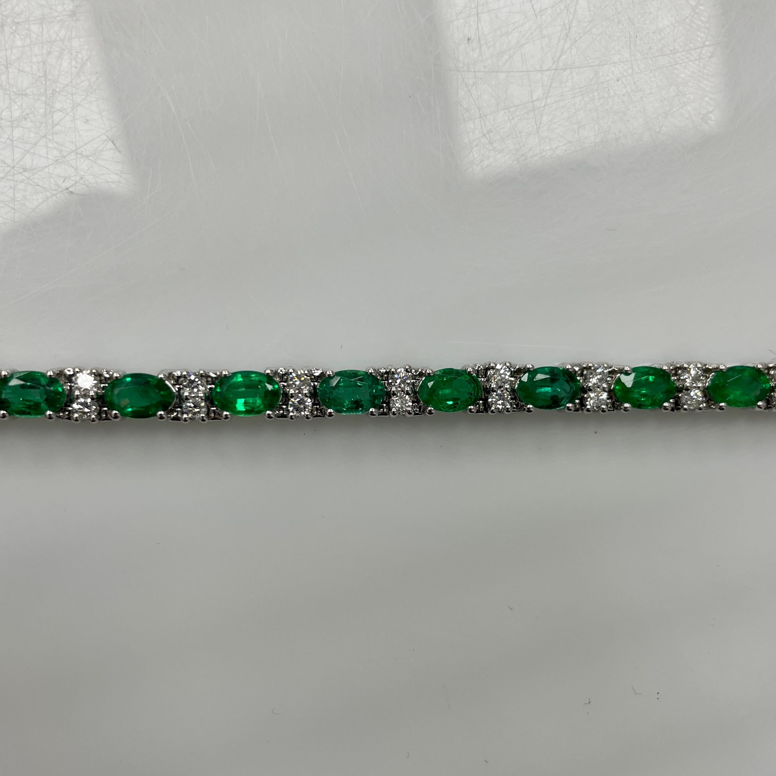 This bracelet holds STUNNING 5x3 oval vibrant emeralds in a 14K white gold bracelet holding 1.30 carats of white diamonds