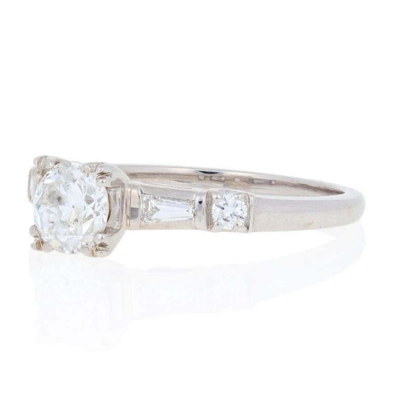 Make the moment you propose even more special with this exquisite engagement piece! Crafted in 18k white gold, this vintage ring showcases a sparkling European cut diamond solitaire, which is close to eyeclean, that is beautifully accompanied by