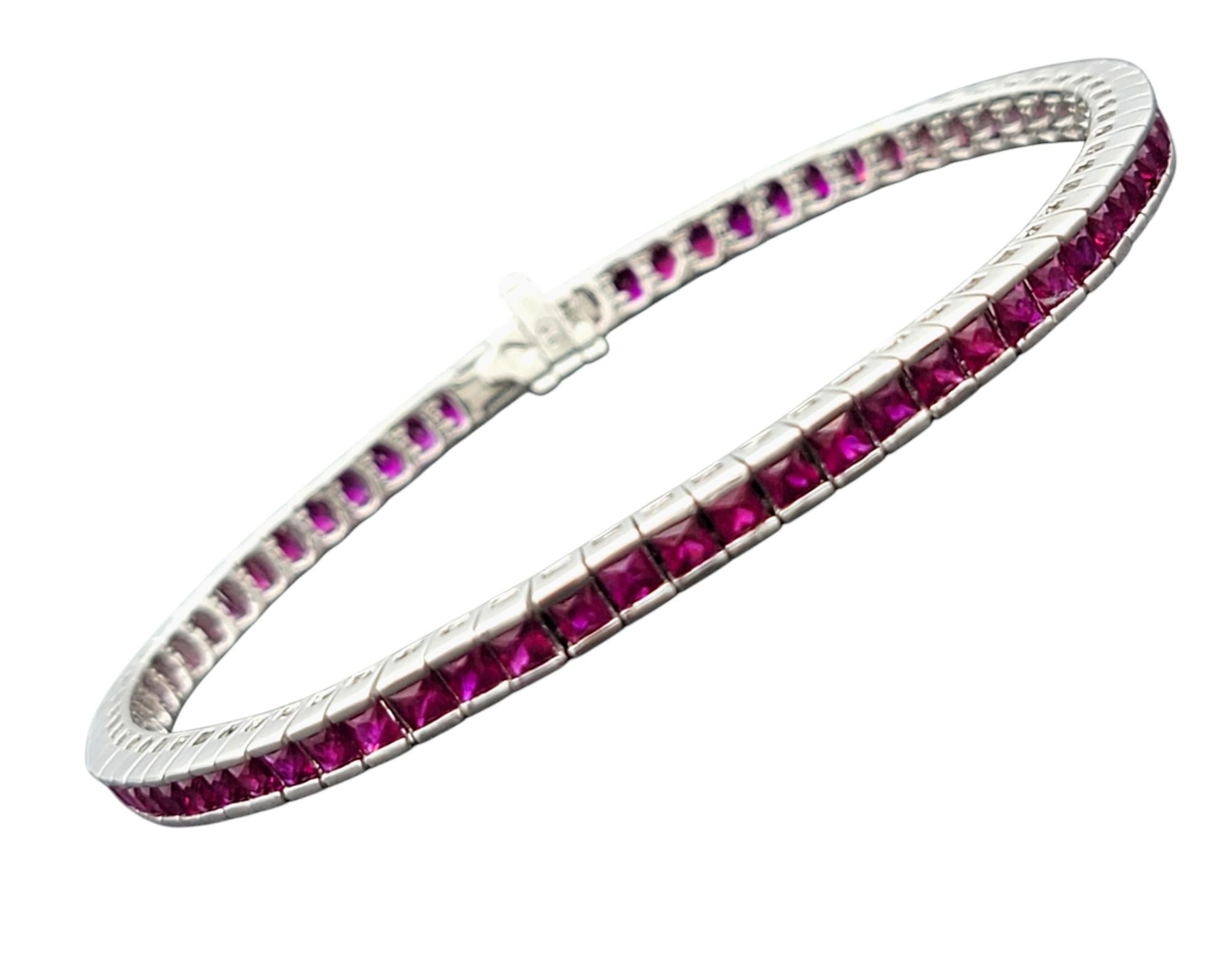 Make a bold statement of elegance with this square-cut ruby tennis bracelet, a dazzling display of vibrant color and refined craftsmanship. Channel-set rubies, each with a rich, fiery hue, line the bracelet in perfect symmetry, creating an