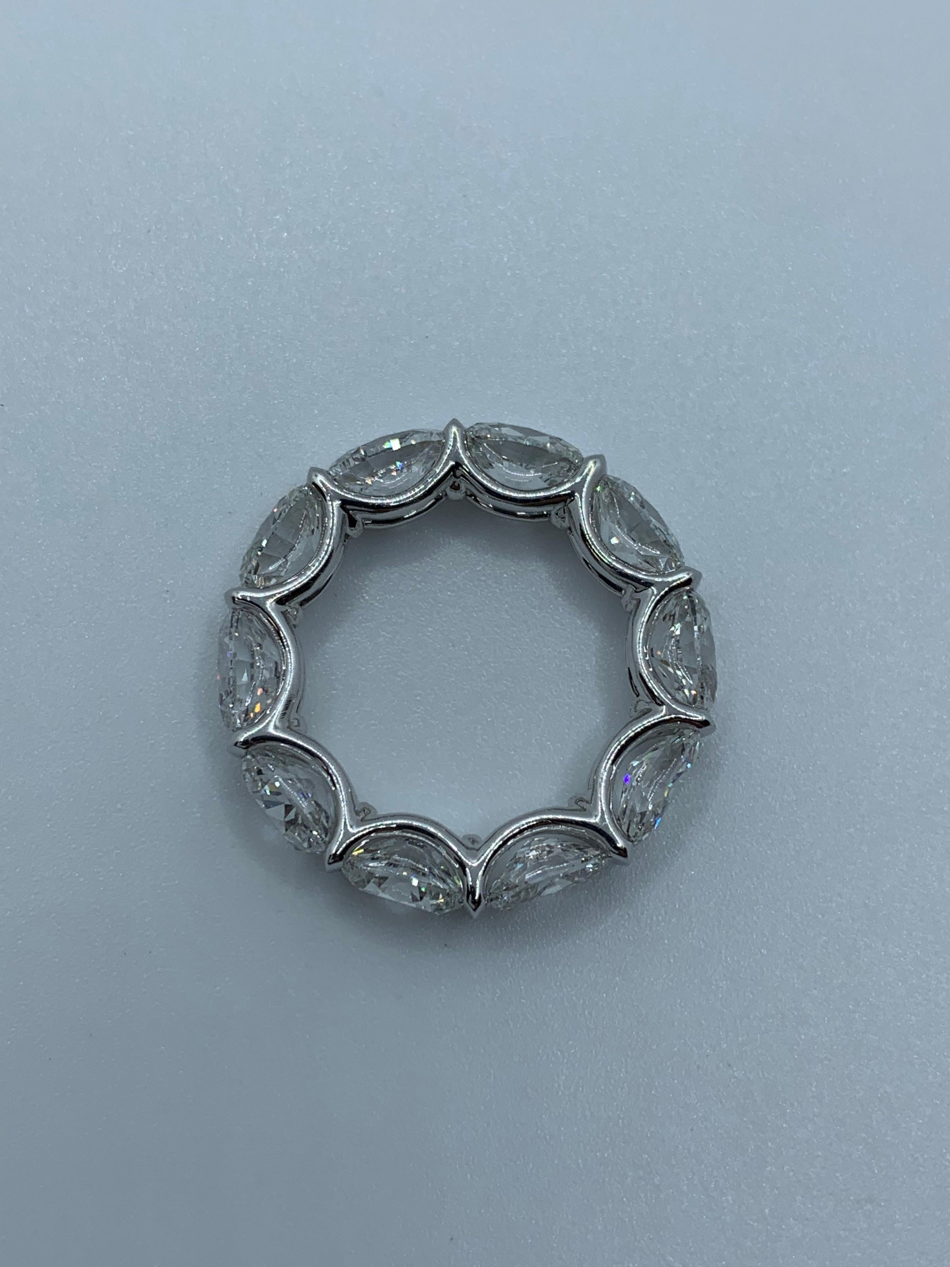 10 Oval Shaped Diamond in an East-West Eternity Band Setting weighing 8.42 Carats and set in Platinum.
Stones are of E-F color and VS-VVS clarity.
Size 6. Can be resized.