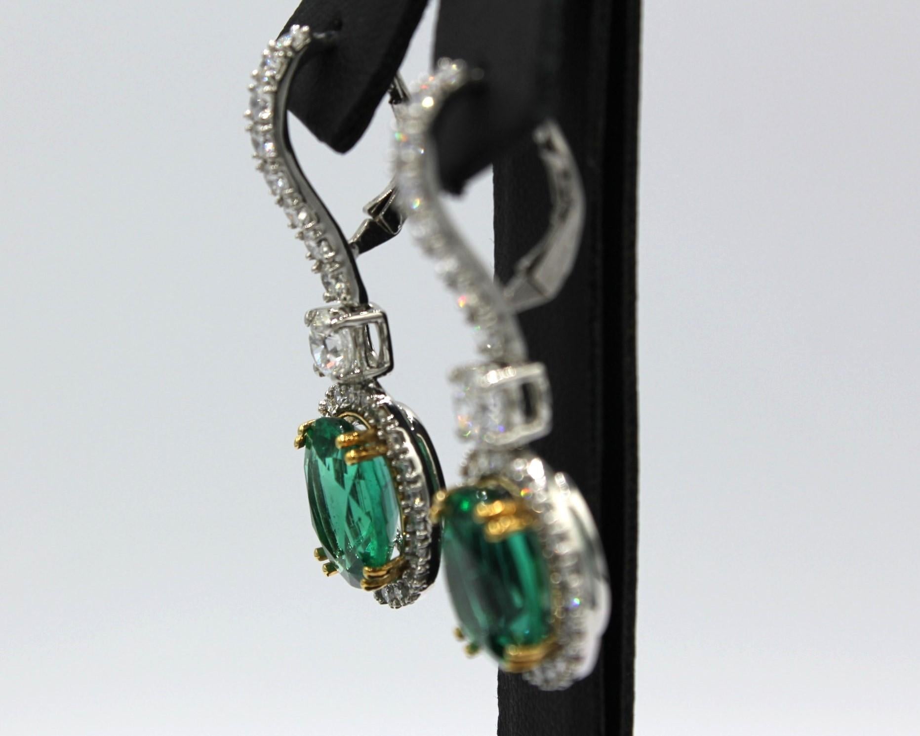 8.44 carats Paired Oval shaped Zambian Emeralds with sixty-two round Diamonds totaling the weight of 2.83 carats. 

This Emerald Diamond Earring will highlight your elegance and uniqueness. 

Item Details:
- Type: Earring
- Metal: 18K Platinum and