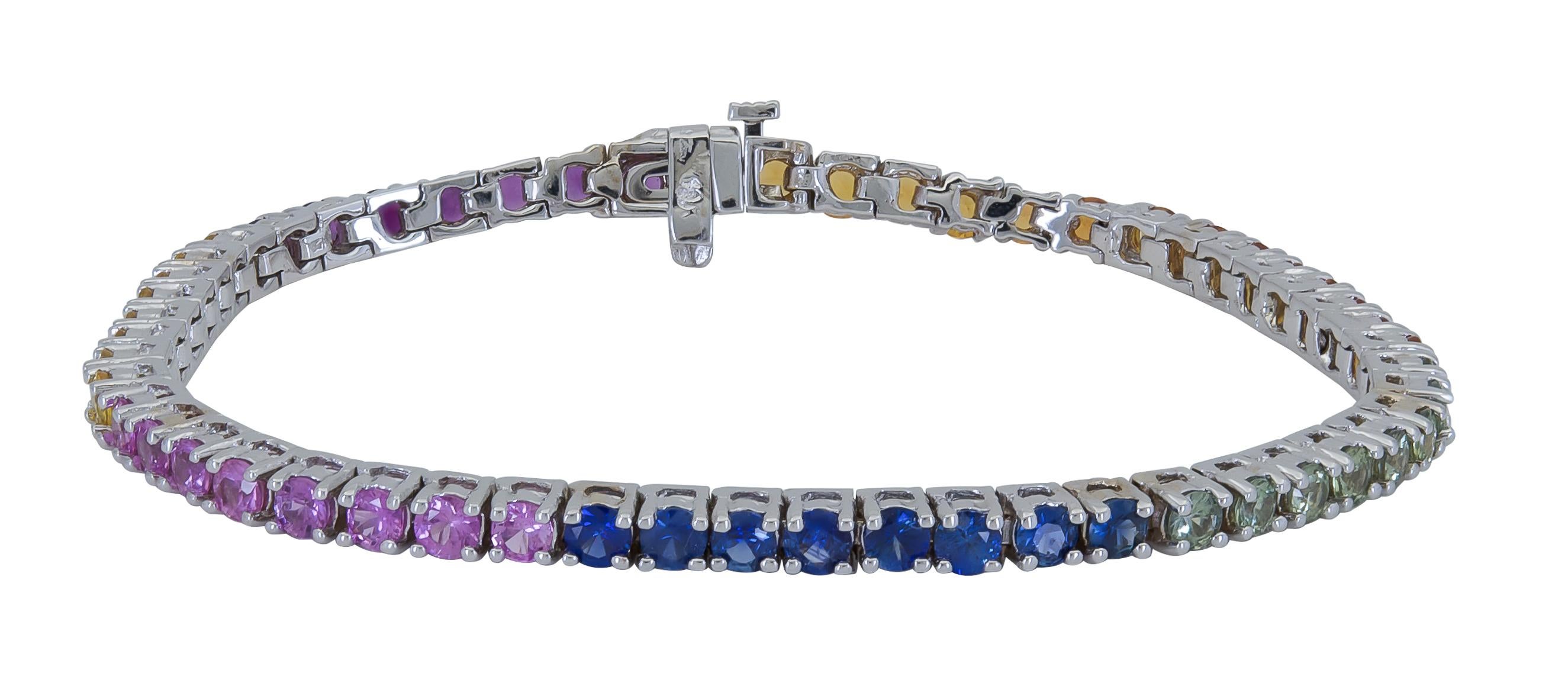 Features a row of vibrant round sapphires of different colors, set in a four prong tennis design. A chic and fashionable piece of jewelry.
Sapphires weigh 8.45 carats total.
Dimensions: 7.25in (L) x 0.13in (W)
Creator: Ely Adams